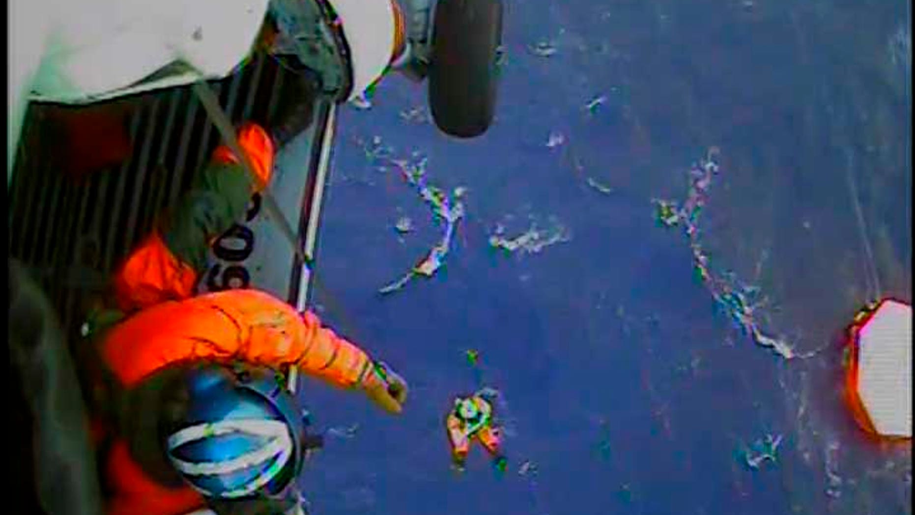 Oct. 29, 2012: A member of the U.S. Coast Guard is lowered to a life raft in the Atlantic Ocean approximately 90 miles southeast of Hatteras, North Carolina. The U.S. Coast Guard rescued 14 of the 16 crew who abandoned the HMS Bounty while in the path of Hurricane Sandy off North Carolina, using helicopters to lift them from life rafts, the Coast Guard said.