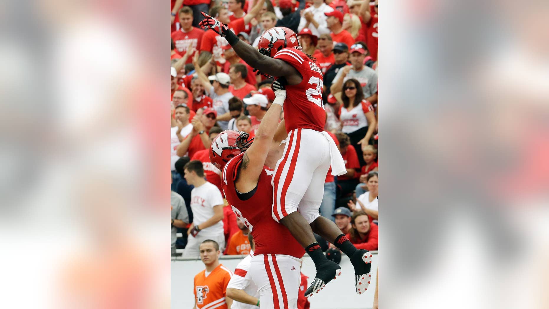 Wisconsin's Melvin Gordon is lifted by teammate Rob Havenstein after Gordon's 69-yard touchdown run during the second half of an NCAA college football game against Bowling Green, Saturday, Sept. 20, 2014, in Madison, Wis. (AP Photo/Morry Gash)