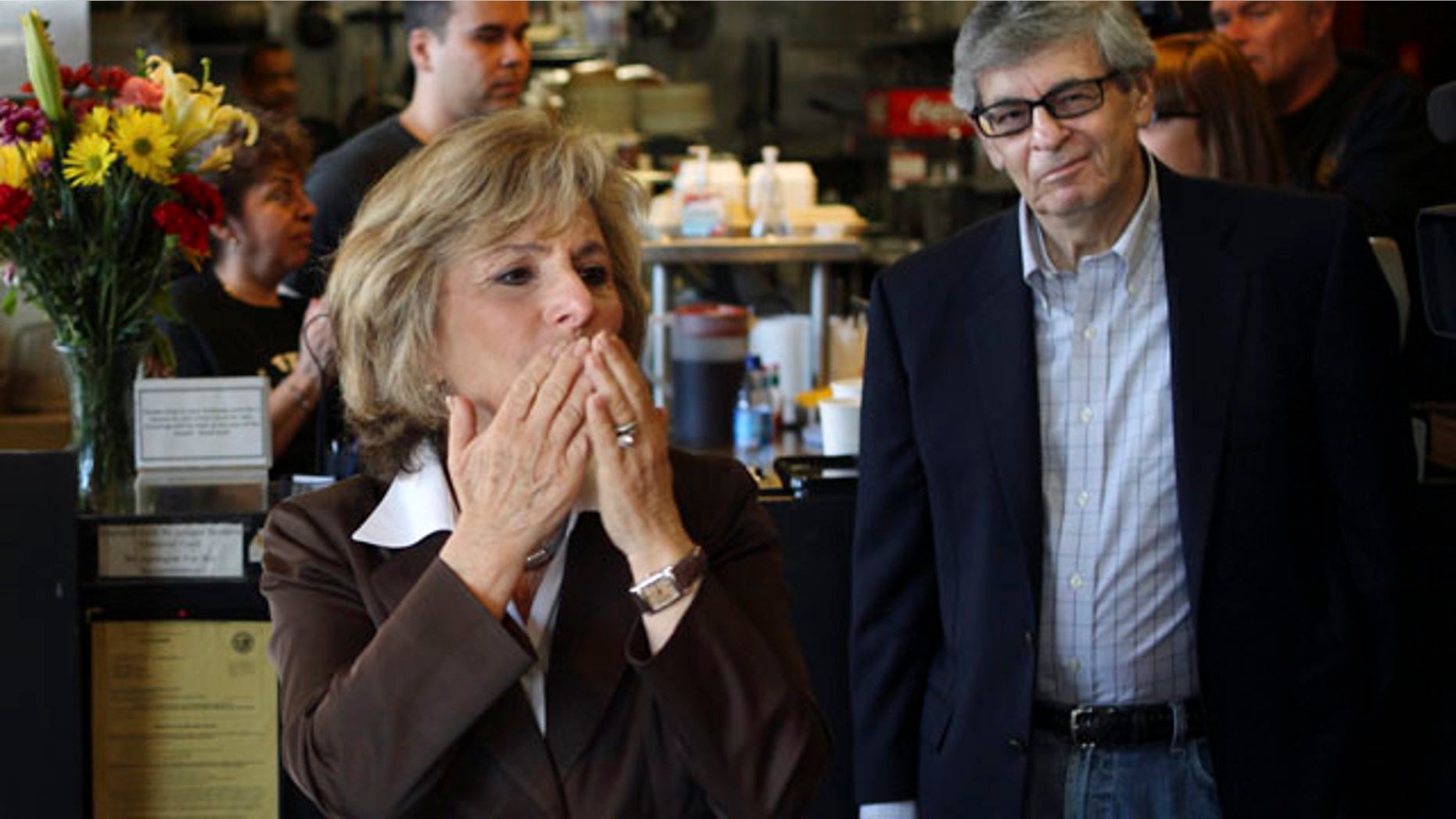 Sen. Barbara Boxer, accompanied by her husband Stewart, right, stops into the Oakland Grill, a favorite eatery, to thank supporters on this Election Day