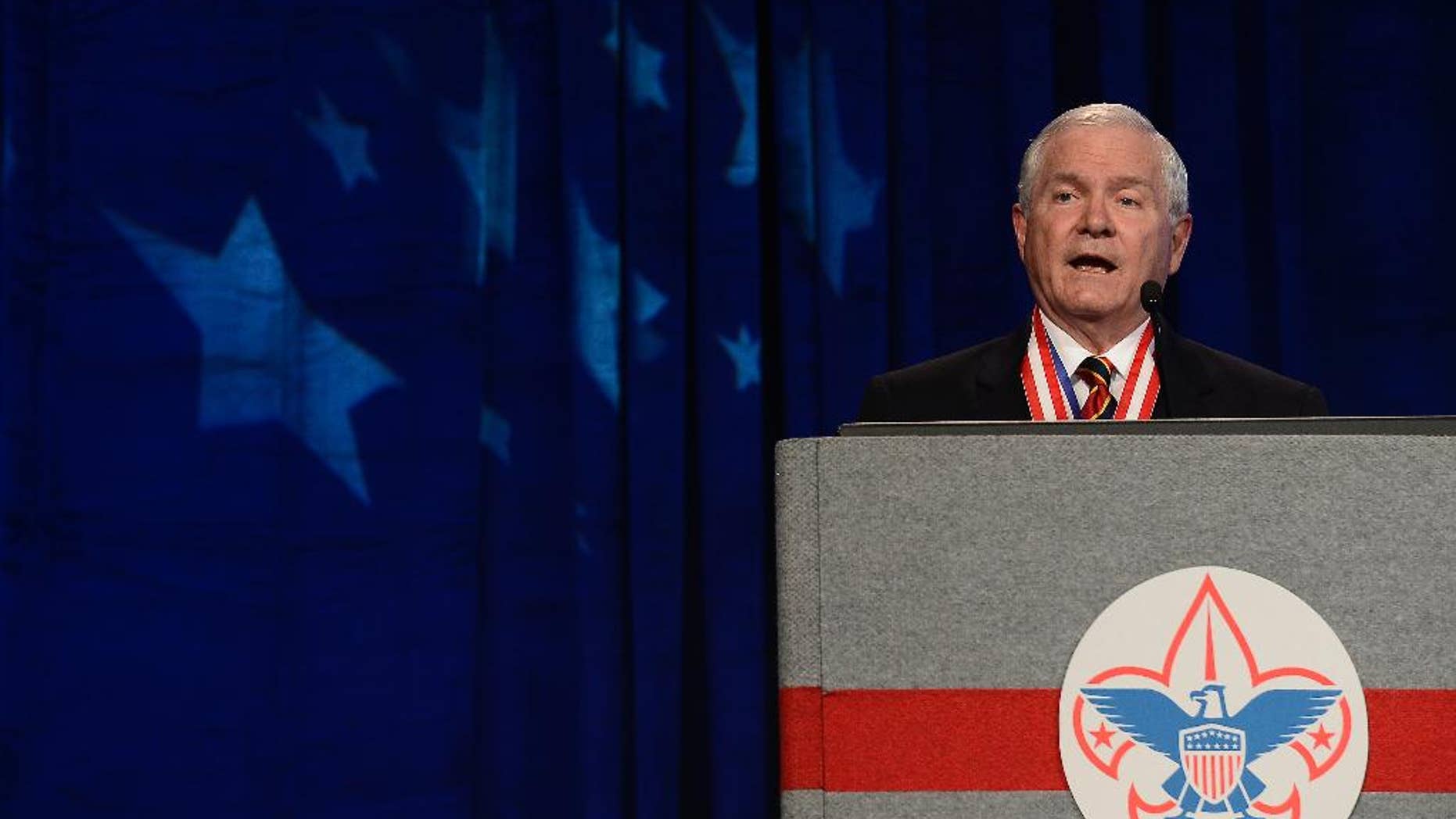 FILE - In this May 23, 2014, file photo, former Defense Secretary Robert Gates addresses the Boy Scouts of America's annual meeting in Nashville, Tenn., after being selected as the organization's new president. The executive committee of the Boy Scouts of America has unanimously approved a resolution that would end the organization's blanket ban on gay adult leaders and let individual scout units set their own policy on the long-divisive issue. The committee action follows an emphatic speech in May by the BSA's president, the former defense secretary declaring that the longstanding ban on participation by openly gay adults was no longer sustainable. (AP Photo/Mark Zaleski, File)