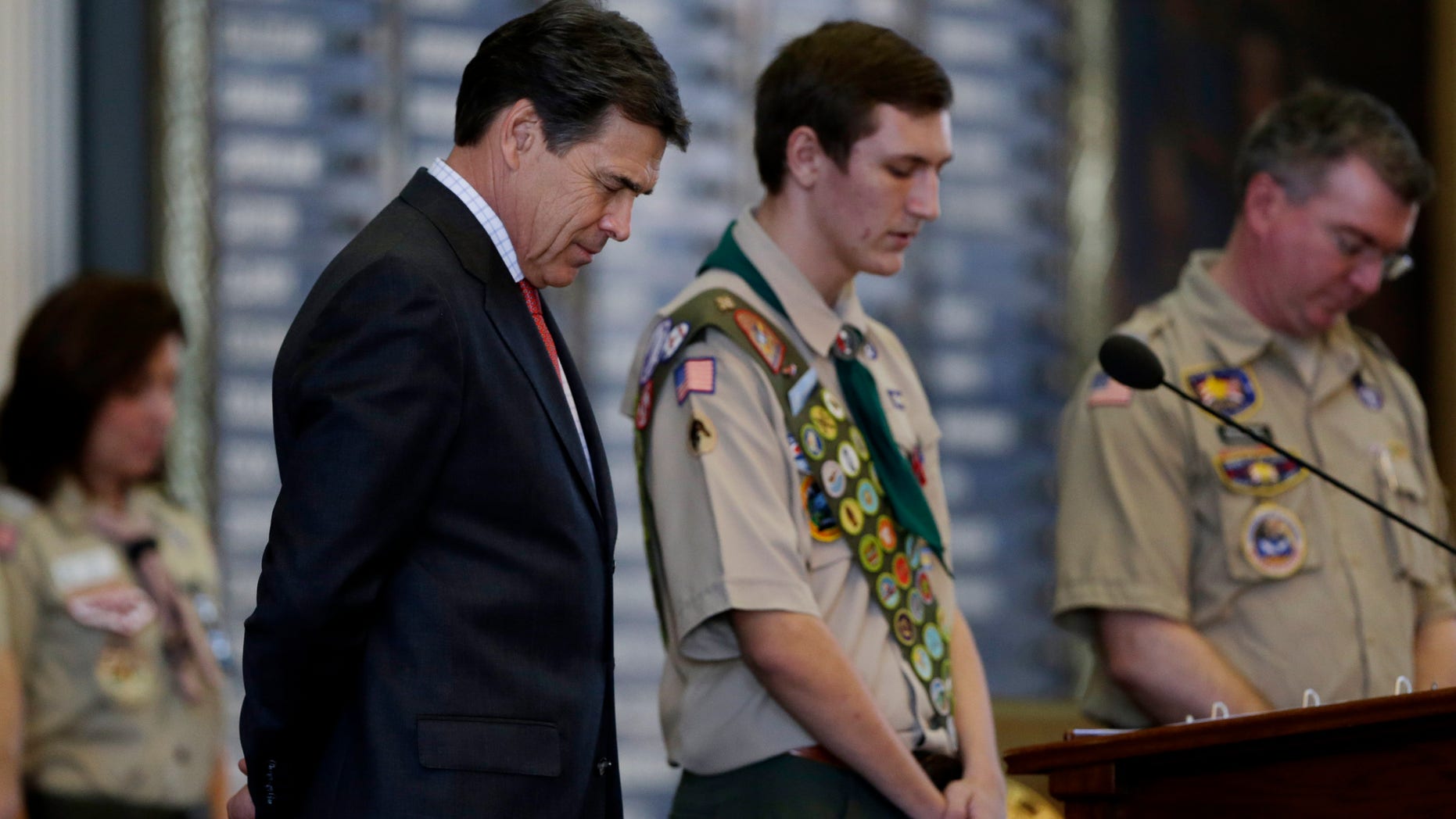 Feb. 2, 2013: Gov. Rick Perry, left, bows his head for the invocation during the annual Boy Scouts Parade and Report to State in the House Chambers at the Texas State Capitol, in Austin, Texas.