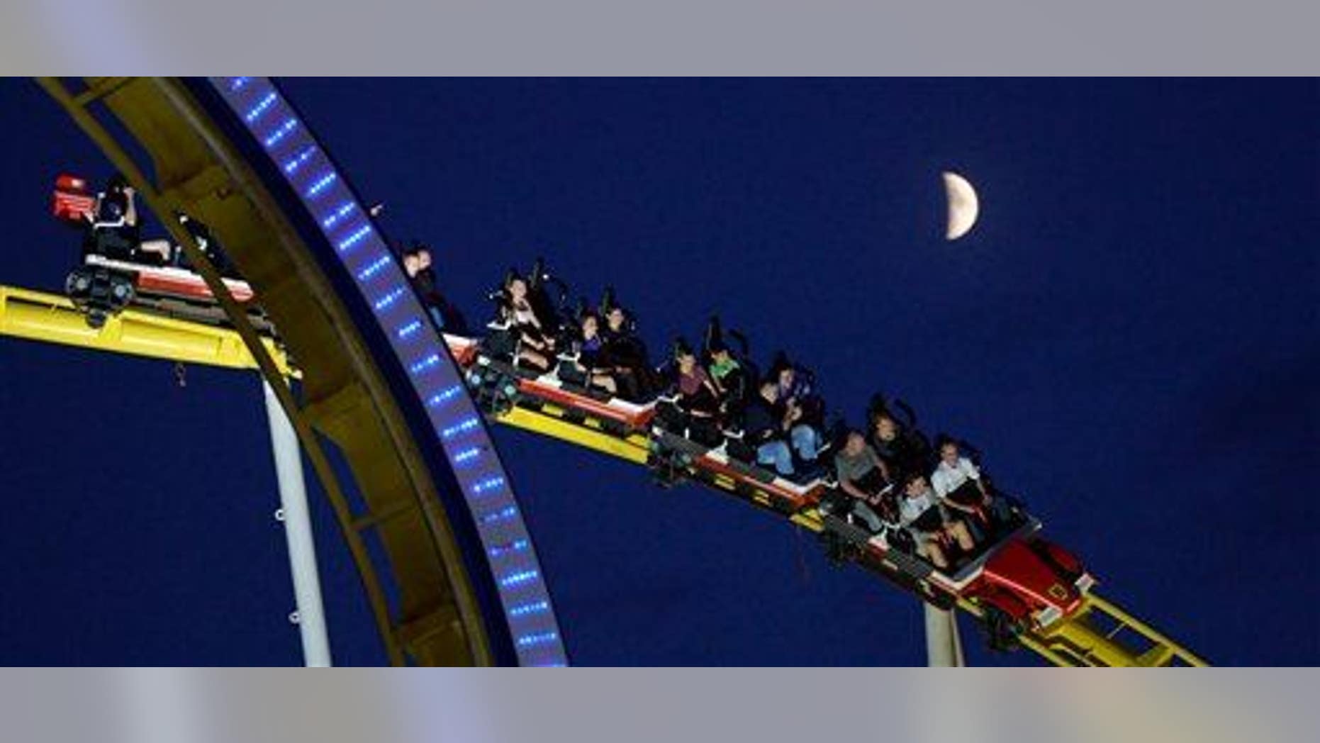 People enjoy a roller-coaster ride on July 4, 2014, in Hannover, Germany.