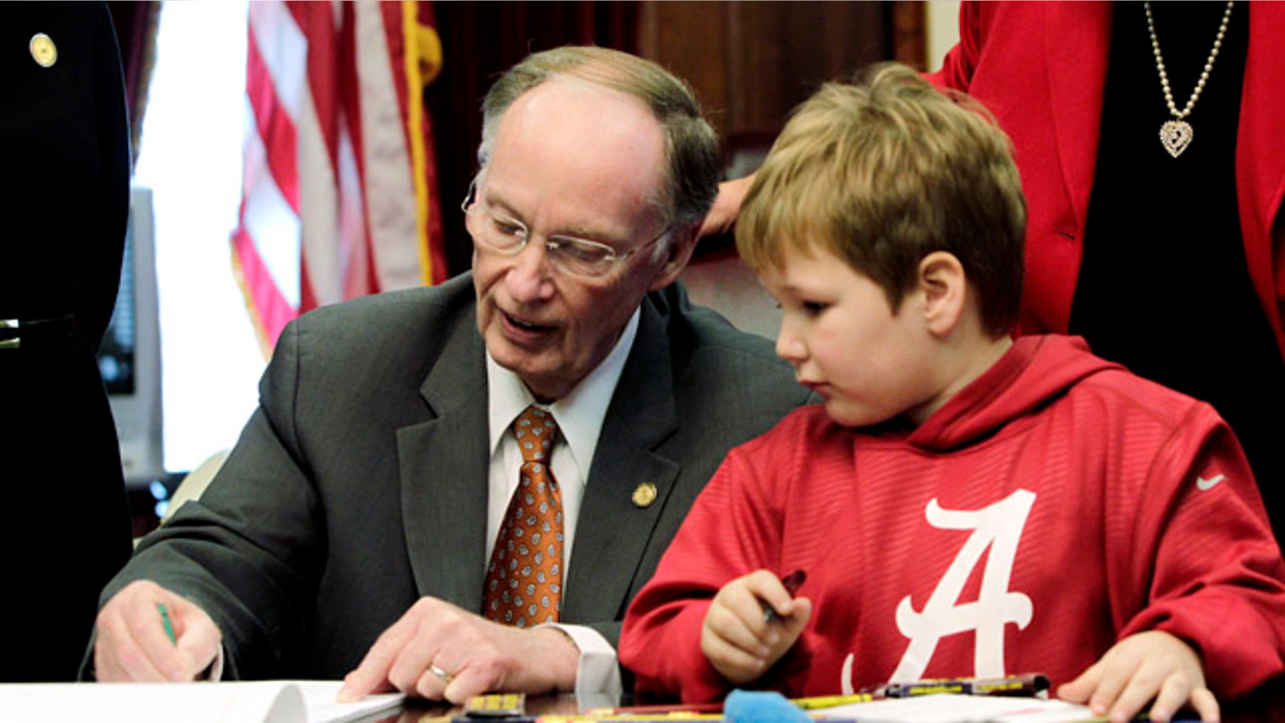 Feb. 13, 2013: Gov. Robert Bentley, left, draws with 6-year-old Ethan Gilman during a visit to the Governor's Office in Montgomery, Ala.