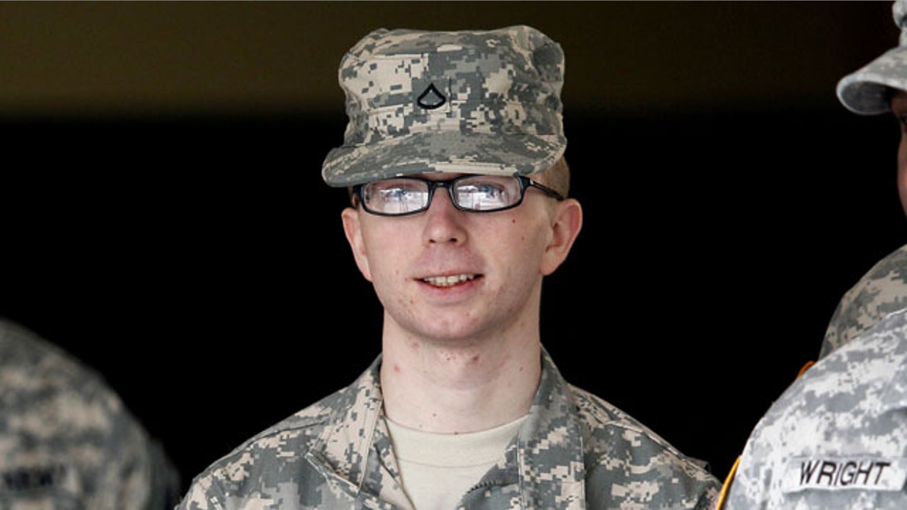 In this file photo taken Dec. 22, 2011, Army Pfc. Bradley Manning is escorted from a courthouse in Fort Meade, Md. An Army officer has ordered a court-martial, Friday, Feb. 3, 2012 for Manning, a low-ranking intelligence analyst charged in the biggest leak of classified information in U.S. history.