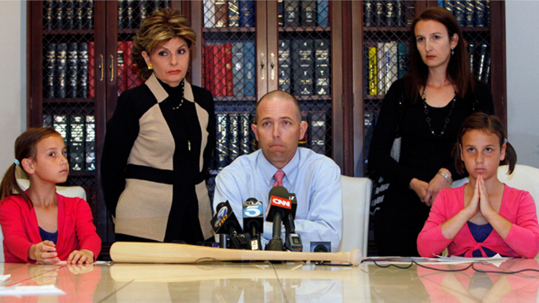 April 27: Justin Quinn, center, with his wife Jessica, right, and their twin daughters: Kylynn, far left, and Taylor, far right, take questions during a news conference organized by Los Angeles attorney Gloria Allred, standing left, in Los Angeles.