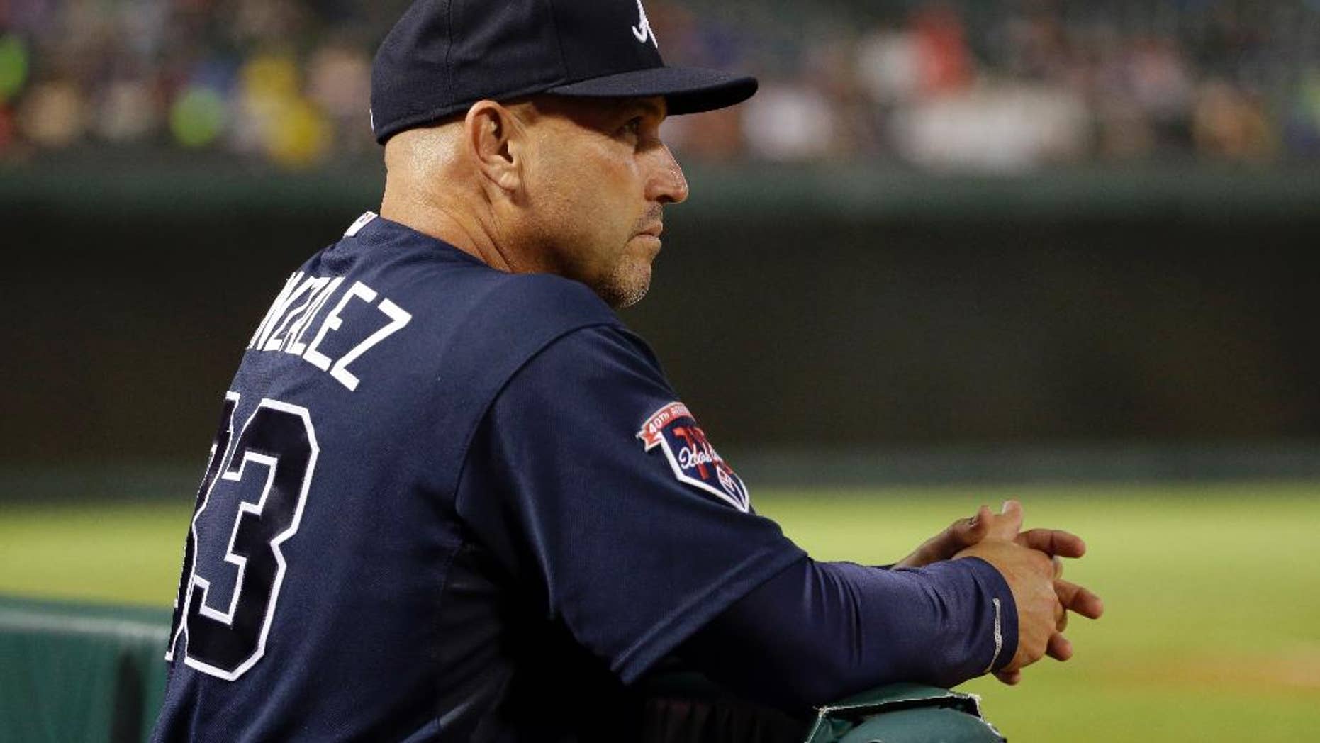 Atlanta Braves manager Fredi Gonzalez watches the Braves' baseball game against the Texas Rangers in the eighth inning Friday, Sept. 12, 2014, in Arlington, Texas. The Rangers won 2-1. (AP Photo/Tony Gutierrez)