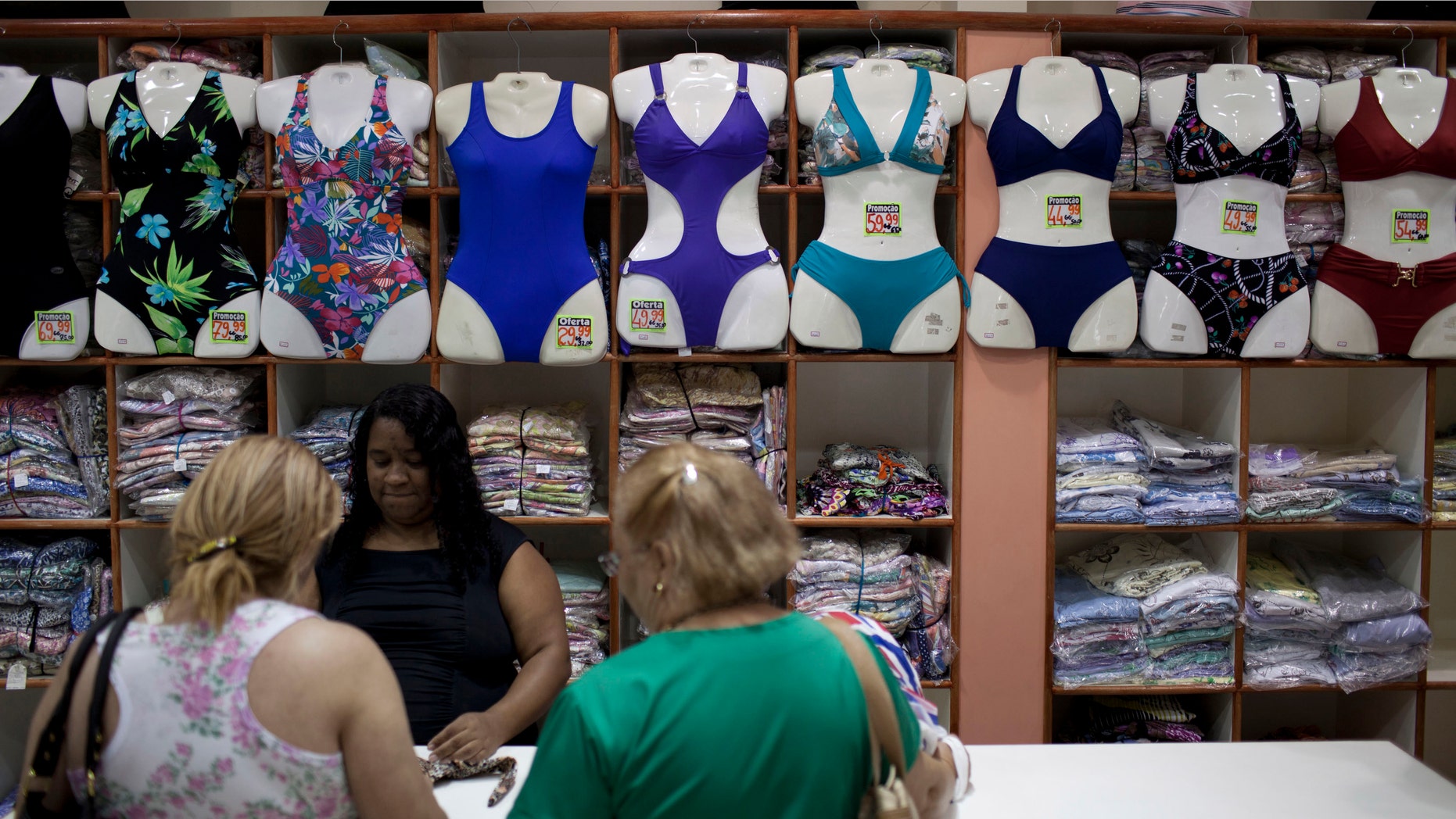 In this photo taken Jan. 27, 2012, people shop for bikinis at a store in Rio de Janeiro, Brazil. A growing number of bikini manufacturers have woken up to Brazil's thickening waistline and are reaching out to the ever-expanding ranks of heavy women with new plus-size lines. (AP Photo/Felipe Dana)