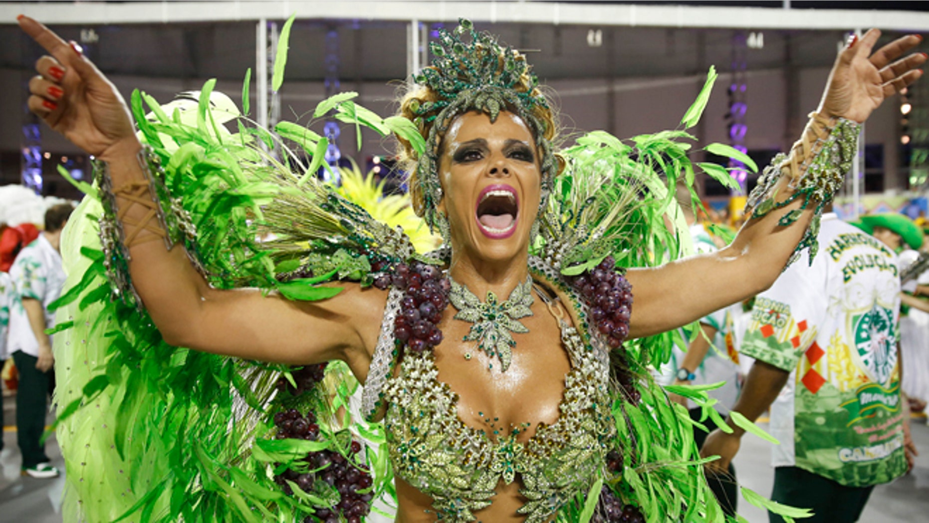 A dancer from the Mancha Verde samba school performs in the Carnival parade at the Sambodromo in Sao Paulo, Brazil, Friday, Feb. 13, 2015. (AP Photo/Andre Penner)