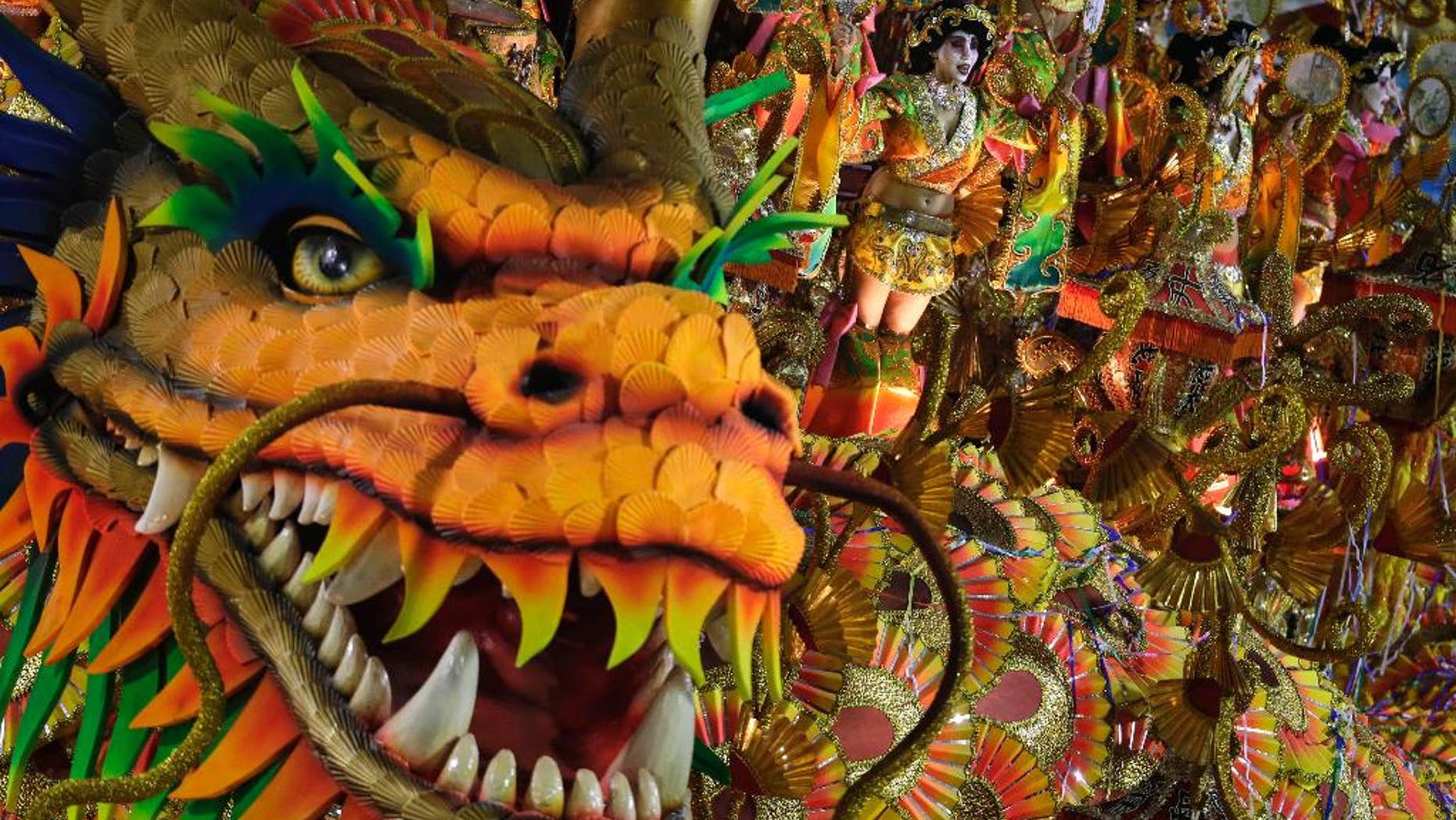 FILE - In this March 3, 2014, file photo, performers from the Beija-Flor samba school parade on a float during carnival celebrations at the Sambadrome in Rio de Janeiro, Brazil. Rio’s O Globo newspaper, one of Brazil’s biggest, reported on Feb. 2015, that the samba group received substantial funding from Equatorial Guinea's President Teodoro Obiang Nguema, one of Africa’s most notorious dictators, an allegation that has sparked controversy on the eve of Brazil’s Carnival celebrations (AP Photo/Felipe Dana, File)