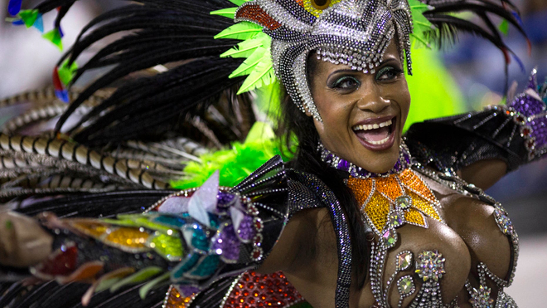 A performer from the Mocidade samba school parades during carnival celebrations at the Sambadrome in Rio de Janeiro, Brazil, Monday, March 3, 2014. Brazil's Carnival is maintaining its frenetic pace, with hundreds of roving parties taking over Rio de Janeiro's streets and famed samba school parades heading into their final night. (AP Photo/Felipe Dana)