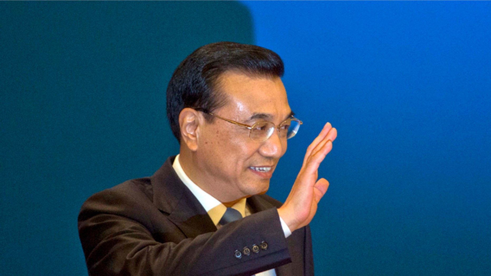 FILE - In this March 15, 2015, file photlo, Chinese Premier Li Keqiang waves as he arrives for a press conference at the end of the National People's Congress in Beijing's Great Hall of the People. Li Keqiang will accelerate plans for an ambitious railway linking Brazils Atlantic coast with a Pacific port in Peru, and announce billions in other investments and trade deals, when he visits Brasilia on Tuesday, May 19, 2015, kicking off a four-nation South American tour that includes Chile, Peru and Colombia. (AP Photo/Ng Han Guan, File)