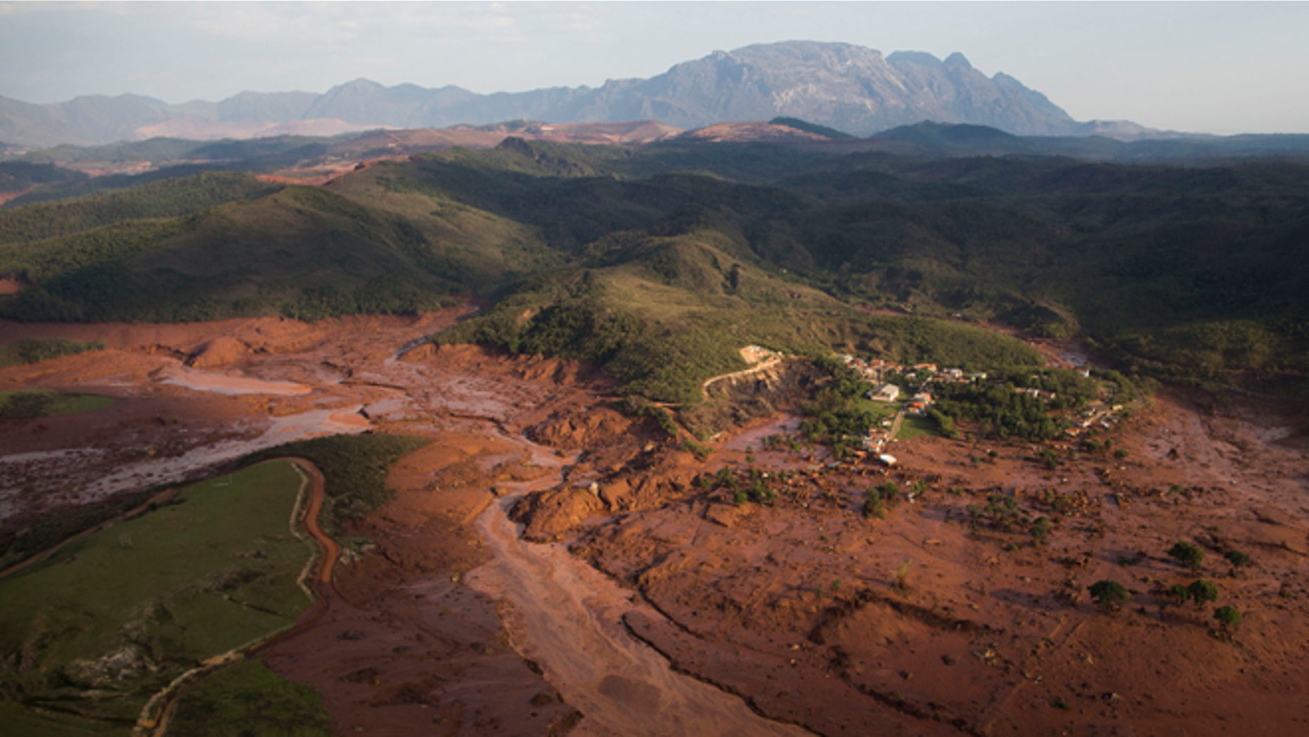 Aerial view of the debris and mud on Thursday, at the small town of Bento Rodrigues after a dam burst in Minas Gerais state, Brazil, Friday, Nov .6, 2015. Brazilian rescuers searched feverishly Friday for possible survivors after two dams burst at an iron ore mine in a southeastern mountainous area. (AP Photo/Felipe Dana)