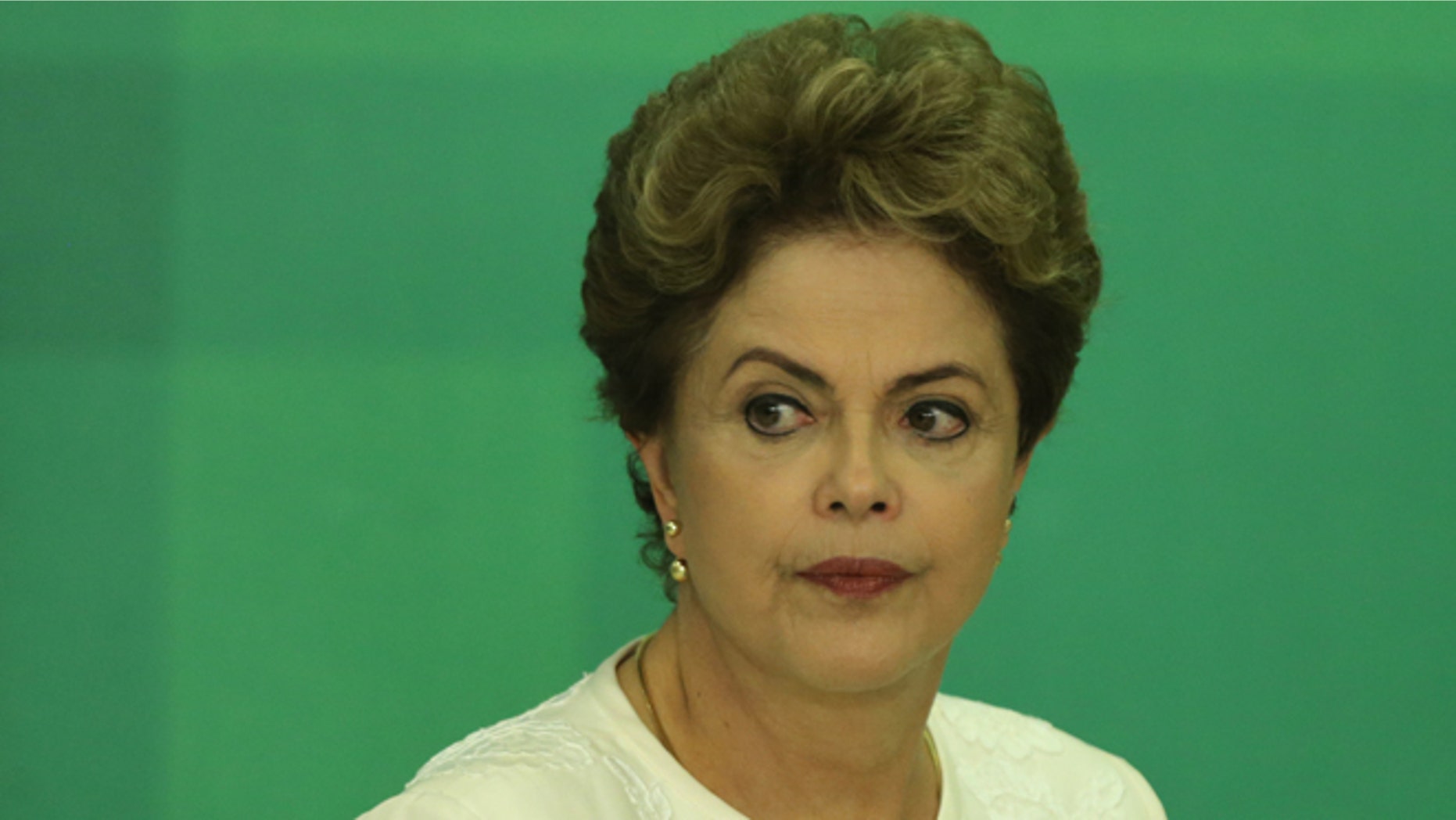 Brazil's President Dilma Rousseff arrives at a press conference after impeachment proceedings were opened against her by the President of Chamber of Deputies Eduardo Cunha, at the Planalto Presidential Palace in Brasilia, Brazil, Wednesday, Dec. 2, 2015. The speaker of the nation's lower house says he's opening the impeachment process based on accusations that Rousseff's government broke fiscal responsibility laws this year. (AP Photo/Eraldo Peres)