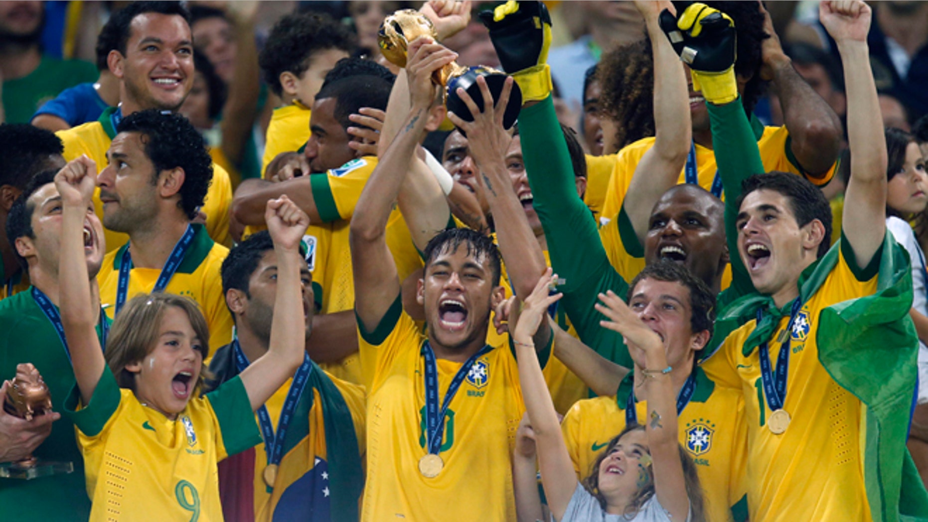 Brazil's Neymar, center, lifts the trophy after winning the soccer Confederations Cup final between Brazil and Spain at the Maracana stadium in Rio de Janeiro, Brazil, Sunday, June 30, 2013. (AP Photo/Victor Caivano)