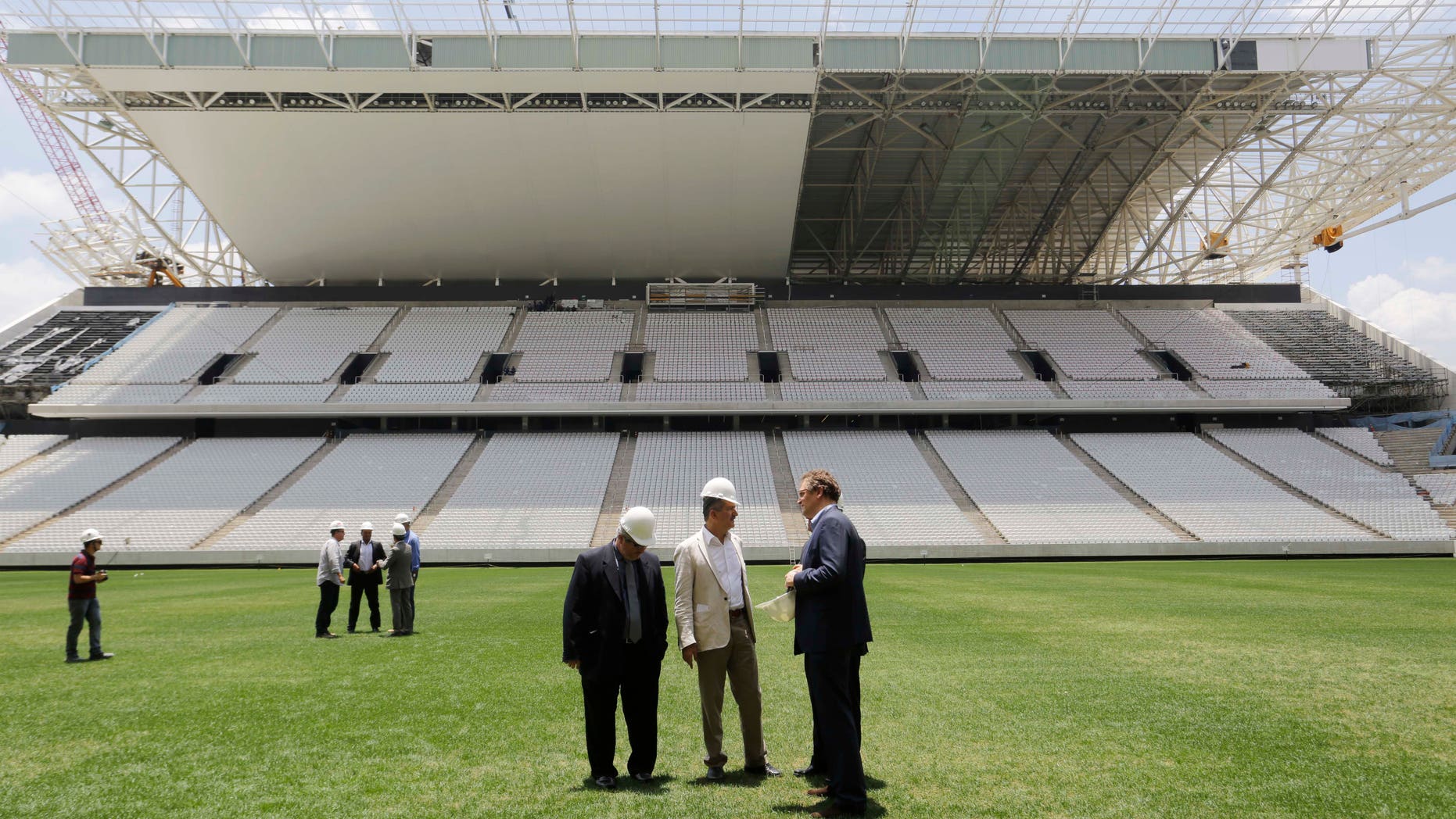 Jerome Valcke, Secretary General of FIFA, right, and Aldo Rebelo, Brazil Sports Minister, center, inspect Arena de Sao Paulo stadium, in Sao Paulo, Brazil, Monday, Jan. 20, 2014. Members of FIFA and the 2014 World Cup Local Organizing Committee started an inspection tour of stadiums in host cities across Brazil. (AP Photo/Nelson Antoine)