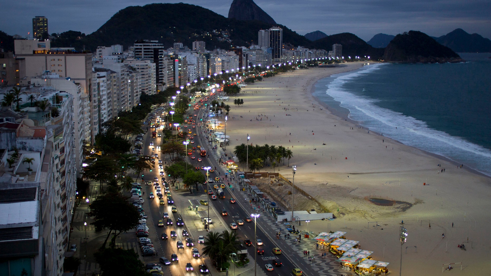 In this photo taken on Friday, Aug. 16, 2013, hotels and apartment buildings line Copacabana beach, in Rio de Janeiro, Brazil, The Brazilian government is concerned that some hotels listed on FIFA's website for the 2014 World Cup plan to overcharge during the tournament. Brazil's tourism board has notified the justice ministry after one of its studies showed that rates will be up to 500 percent more expensive during the World Cup in some hotels from the agency MATCH Services, which is listed on FIFA's website. The board says "it's probable that MATCH is exercising intermediation fees that are a lot higher than usually exercised in the tourism market." MATCH denied any wrongdoing on Saturday, Aug. 17, saying it "provides a totally transparent price structure." (AP Photo/Felipe Dana)