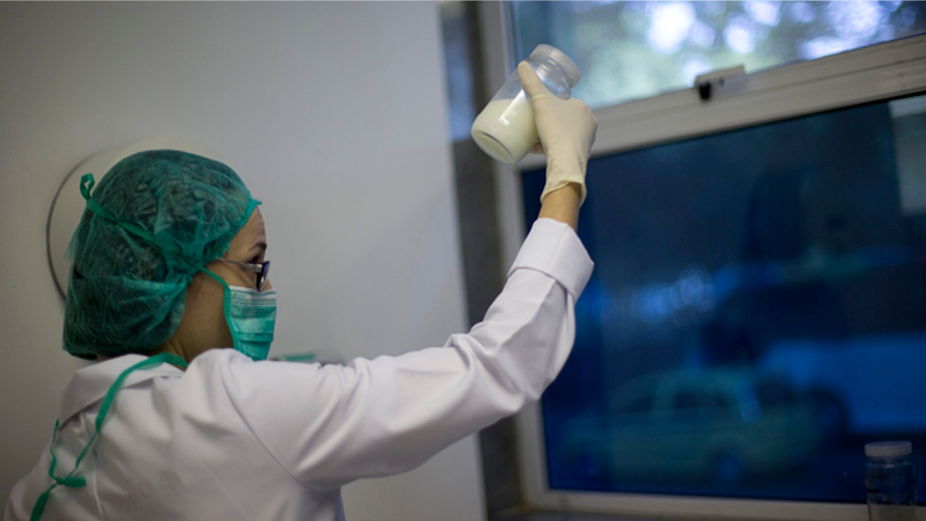 A lab technician examines the quality of donated human milk at the Fernandes Figueira Institute in Rio de Janeiro.