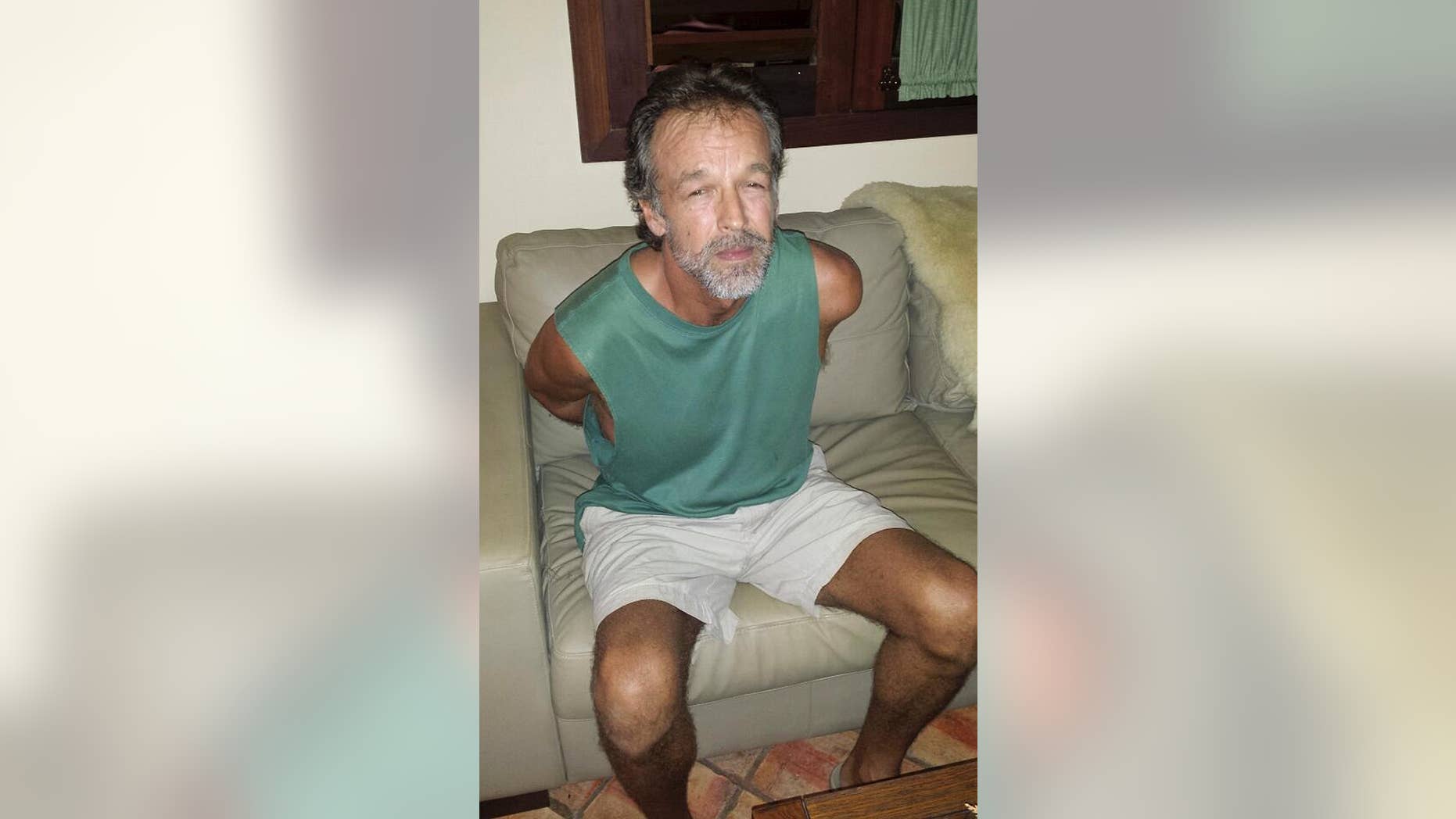 In this photo released by Rio Grande do Norte State Security secretary, American sect leader Victor Arden Barnard sits in a police station after being detained at Pipa beach, in the Northeastern state of Rio Grande do Norte, Brazil, Friday, Feb. 27, 2015. Barnard is facing 59 counts of criminal sexual conduct related to two young women who said they were abused for nearly a decade at his secluded River Road Fellowship in Minnesota. (AP Photo/Rio Grande do Norte State Security Secretary)