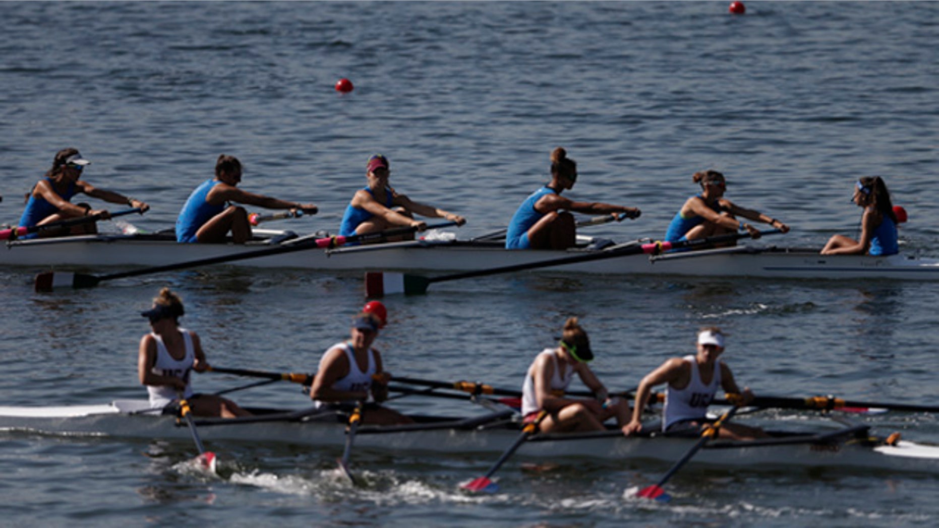 Aug. 4, 2015: Teams of rowers from Italy, top, and the U.S., bottom, practice for the 2015 World Rowing Junior Championships on Rodrigo de Freitas lake in Rio de Janeiro, Brazil. (AP Photo/Silvia Izquierdo)