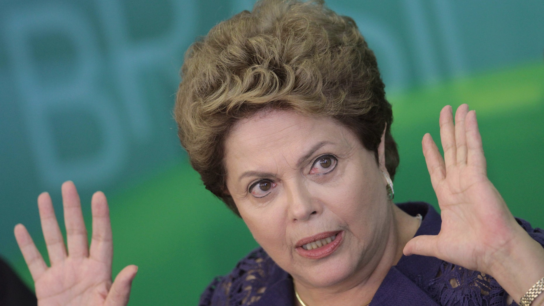 FILE - In this Dec. 22, 2014 file photo, Brazil's President Dilma Rousseff gives a press conference at Planalto presidential palace in Brasilia, Brazil. Rousseff asked Brazilians for patience, on Sunday, March 8, 2015, as the country faces a flagging economy and a widening corruption probe involving the state-run oil company and dozens of top politicians. (AP Photo/Eraldo Peres, File)