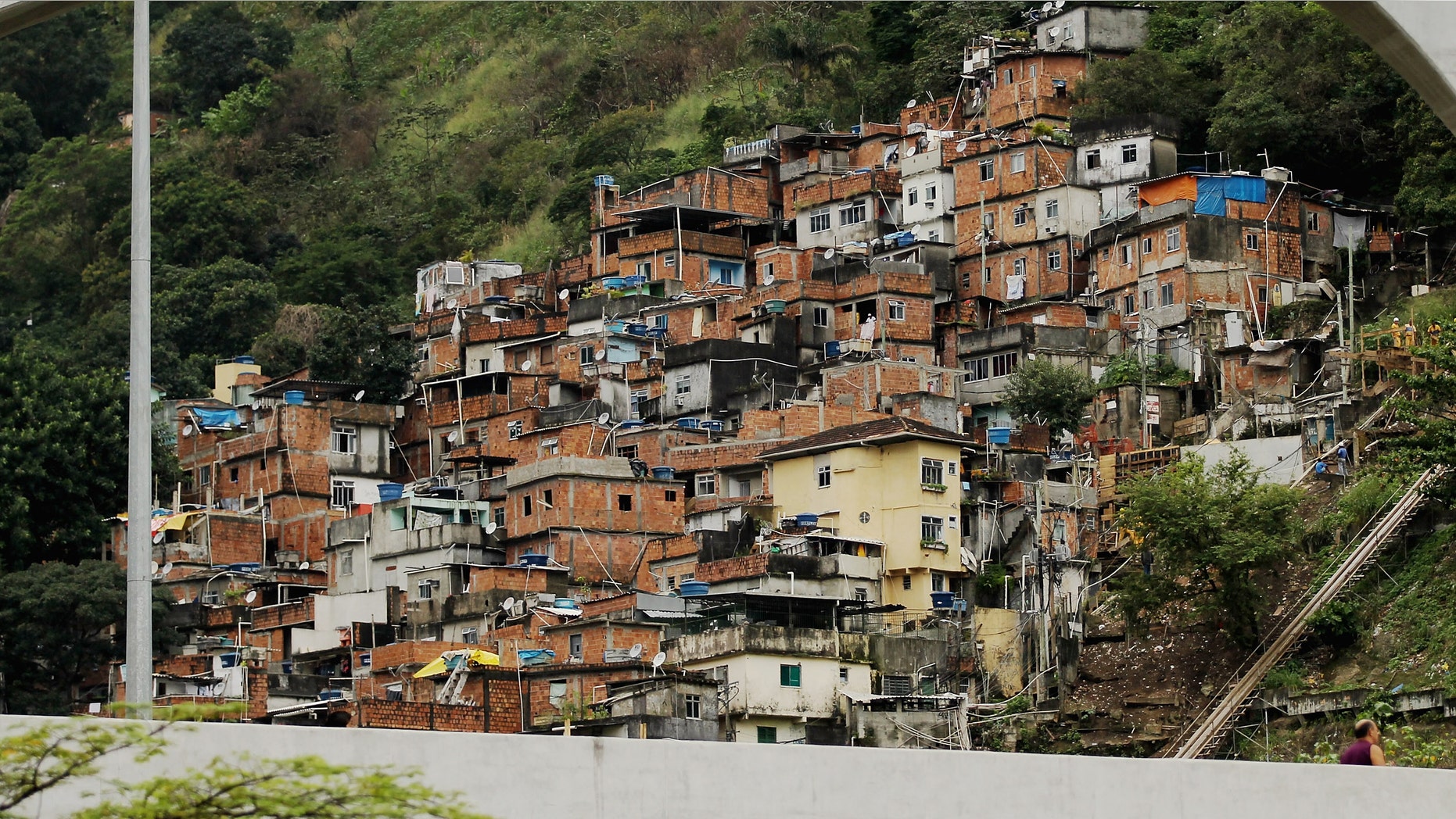 A "pacified" favela, or squatter settlement, is seen on a forested hillside on June 21, 2012 in Rio de Janeiro, Brazil. Rio de Janieroâs authorities have successfully "pacified" a number of formerly crime-ridden favelas in the city. (Photo by Mario Tama/Getty Images)