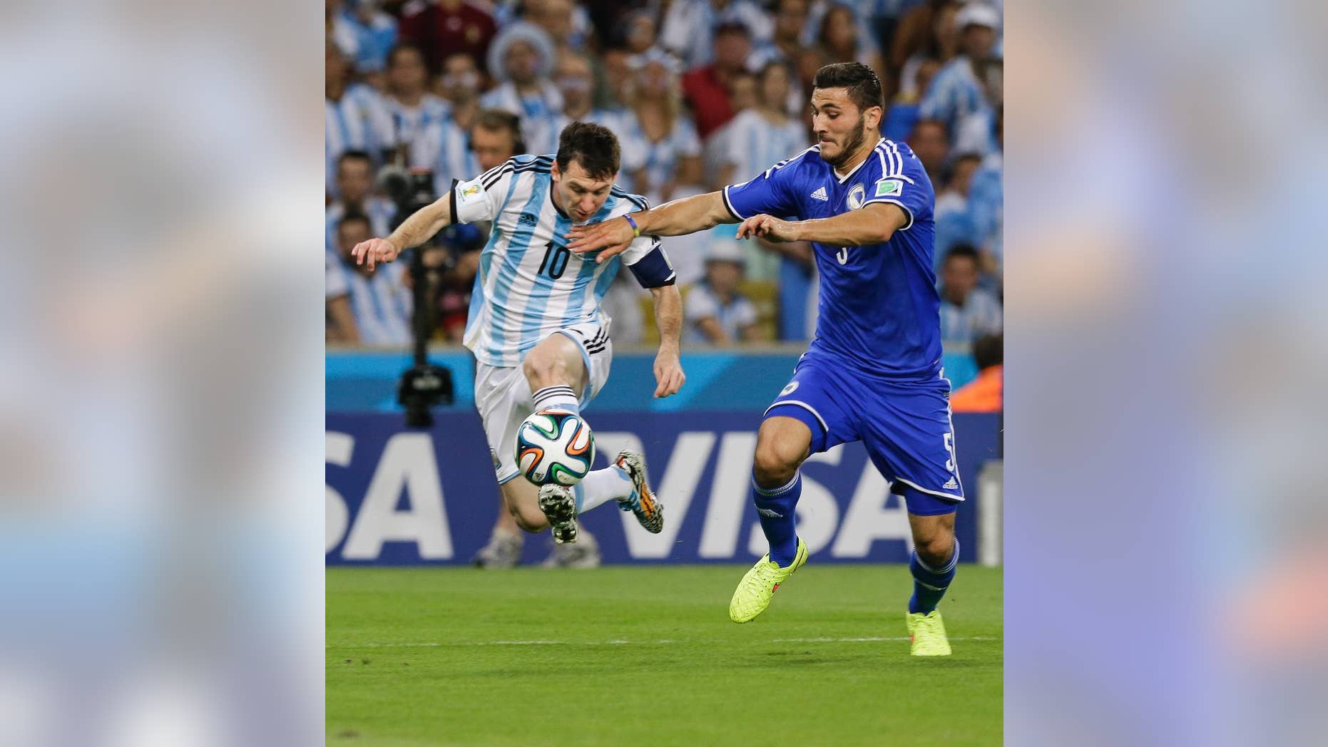 Bosnia's Sead Kolasinac, right, tries to stop Argentina's Lionel Messi (10) during their group F World Cup soccer match at the Maracana Stadium in Rio de Janeiro, Brazil, Sunday, June 15, 2014. (AP Photo/Thanassis Stavrakis)