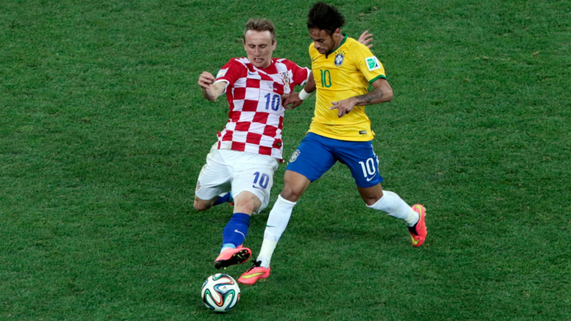 Croatia's Luka Modric, left, and Brazil's Neymar challenge for the ball during the group A World Cup soccer match between Brazil and Croatia, the opening game of the tournament, in the Itaquerao Stadium in Sao Paulo, Brazil, Thursday, June 12, 2014.