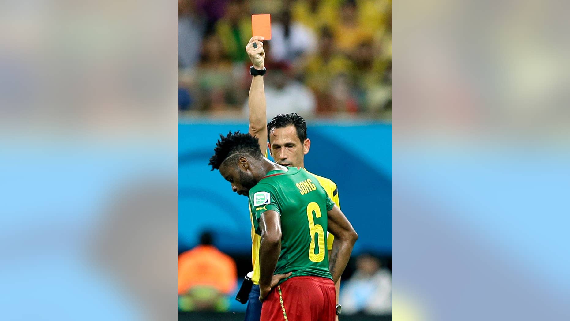 FILE - In this Wednesday, June 18, 2014 file photo, referee Pedro Proenca from Portugal gives a red card to Cameroon's Alex Song during the group A World Cup soccer match between Cameroon and Croatia at the Arena da Amazonia in Manaus, Brazil. Cameroon's football federation said late Monday, June 30, 2014, it will investigate allegations of match-fixing by its team at the World Cup and the possible existence of "seven bad apples" in the squad. (AP Photo/Themba Hadebe, File)