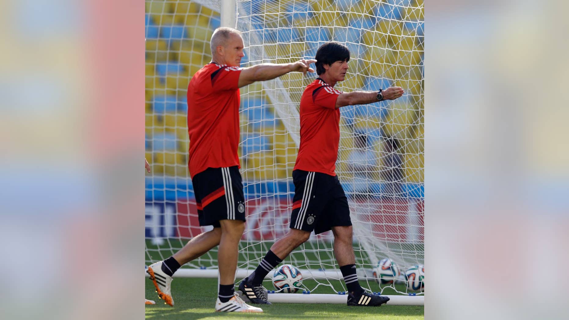 Germany's head coach Joachim Loew, right, with an assistant, check the pitch during an official training session a day prior to the quarter final World Cup soccer match between France and Germany at the Maracana stadium in Rio de Janeiro, Brazil, Thursday, July 3, 2014. (AP Photo/Thanassis Stavrakis)