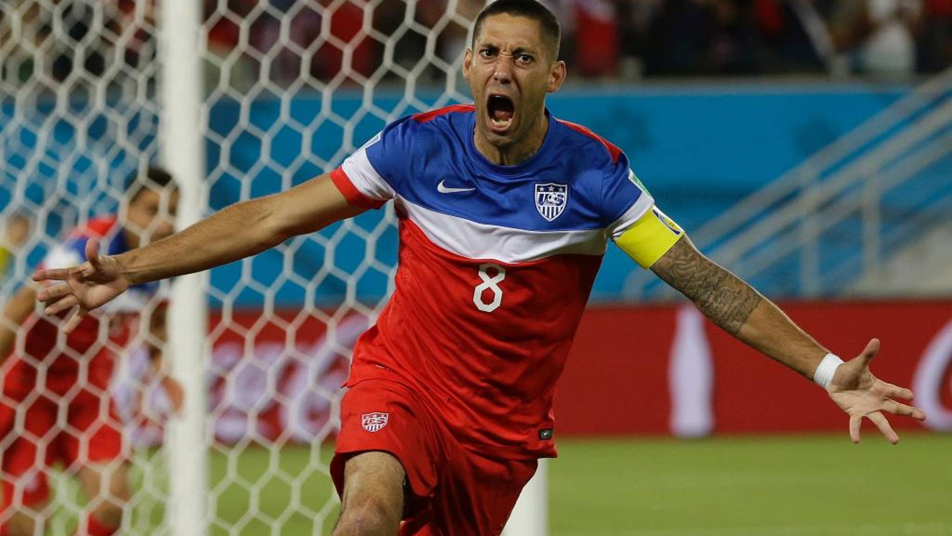 United States' Clint Dempsey celebrates after scoring the opening goal during the group G World Cup soccer match between Ghana and the United States at the Arena das Dunas in Natal, Brazil, Monday, June 16, 2014. (AP Photo/Ricardo Mazalan)
