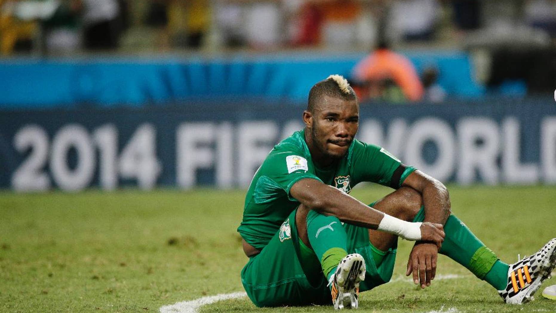 Ivory Coast's Serey Die sits on the pitch after Greece's 2-1 victory over Ivory Coast during the group C World Cup soccer match between Greece and Ivory Coast at the Arena Castelao in Fortaleza, Brazil, Tuesday, June 24, 2014. (AP Photo/Christophe Ena)