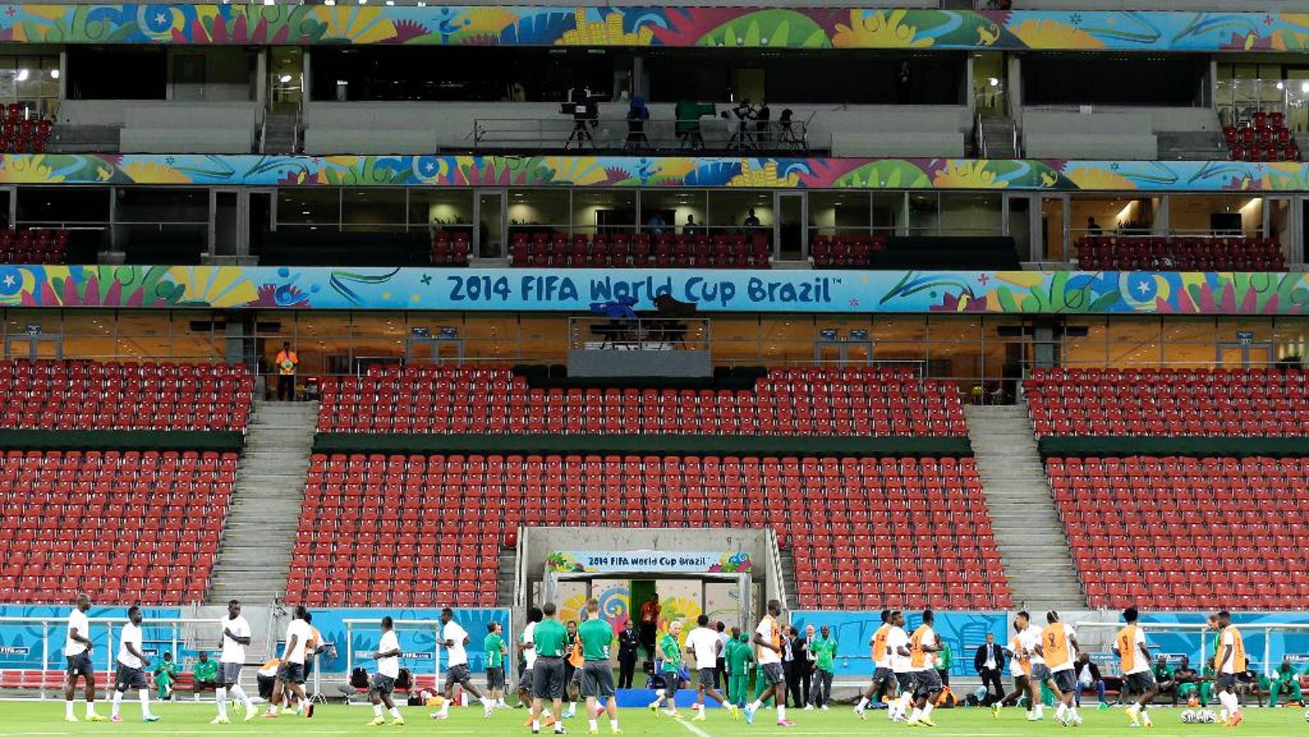 Ivory Coast's players warm up during a training session of Ivory Coast at the Arena Pernambuco in Recife, Brazil, Friday, June 13, 2014. Ivory Coast play in group C of the 2014 soccer World Cup. (AP Photo/Shuji Kajiyama)