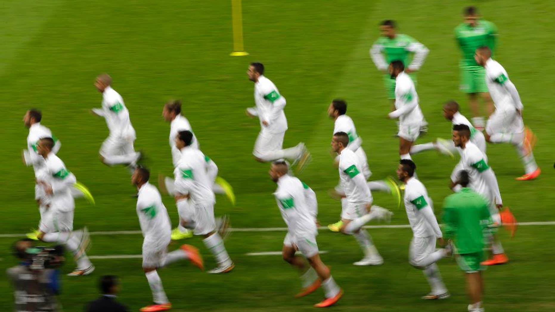 Algeria national soccer team players warm up during an official training session the day before the group H World Cup soccer match between South Korea and Algeria at the Estadio Beira-Rio in Porto Alegre, Brazil, Saturday, June 21, 2014. (AP Photo/Lee Jin-man)