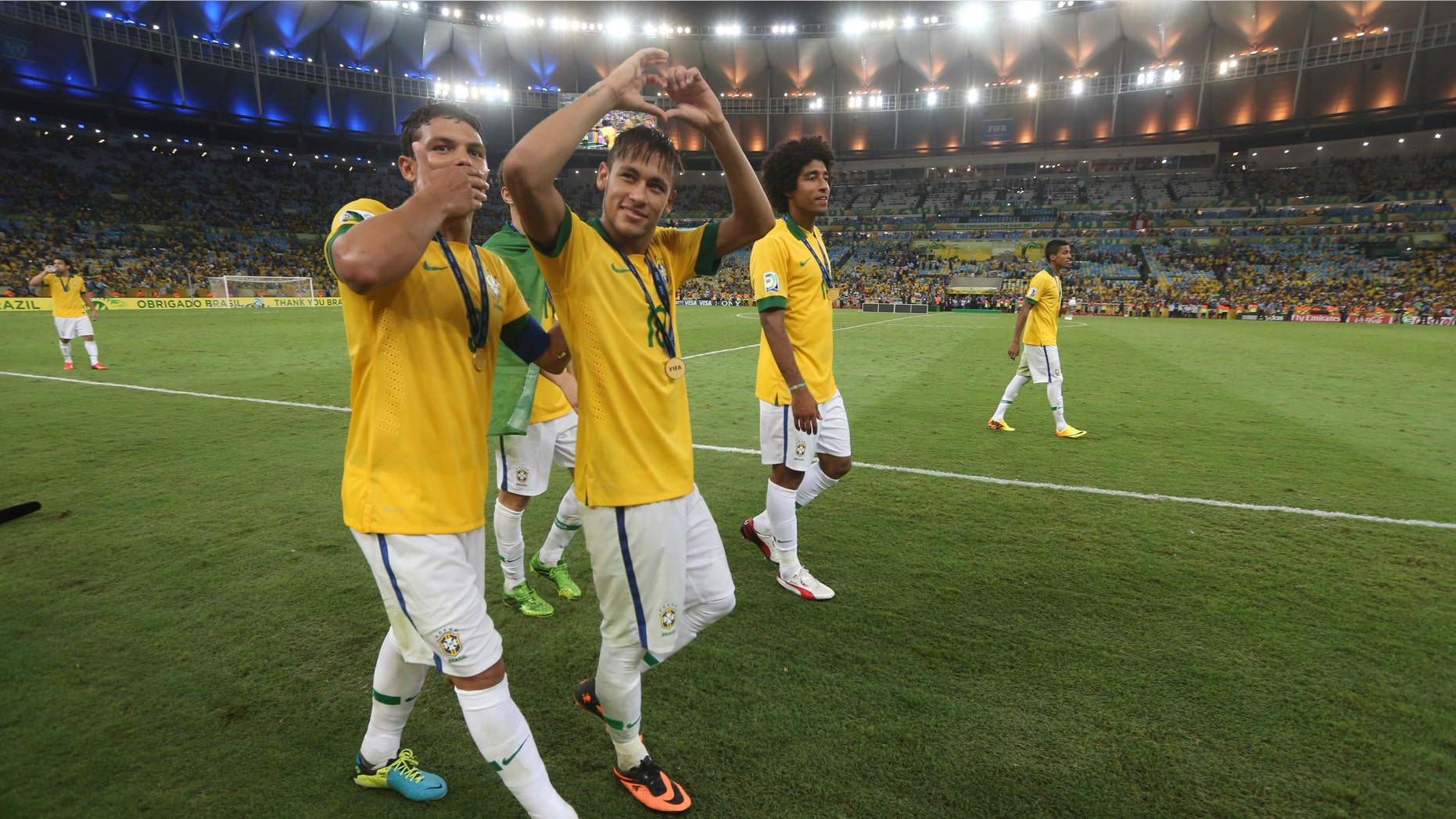 Brazil's Thiago Silva, left, Neymar and Dante celebrate after the soccer Confederations Cup final match against Spain at the Maracana stadium in Rio de Janeiro, Brazil, Sunday, June 30, 2013. Brazil won 3-0. (AP Photo/Andre Penner)