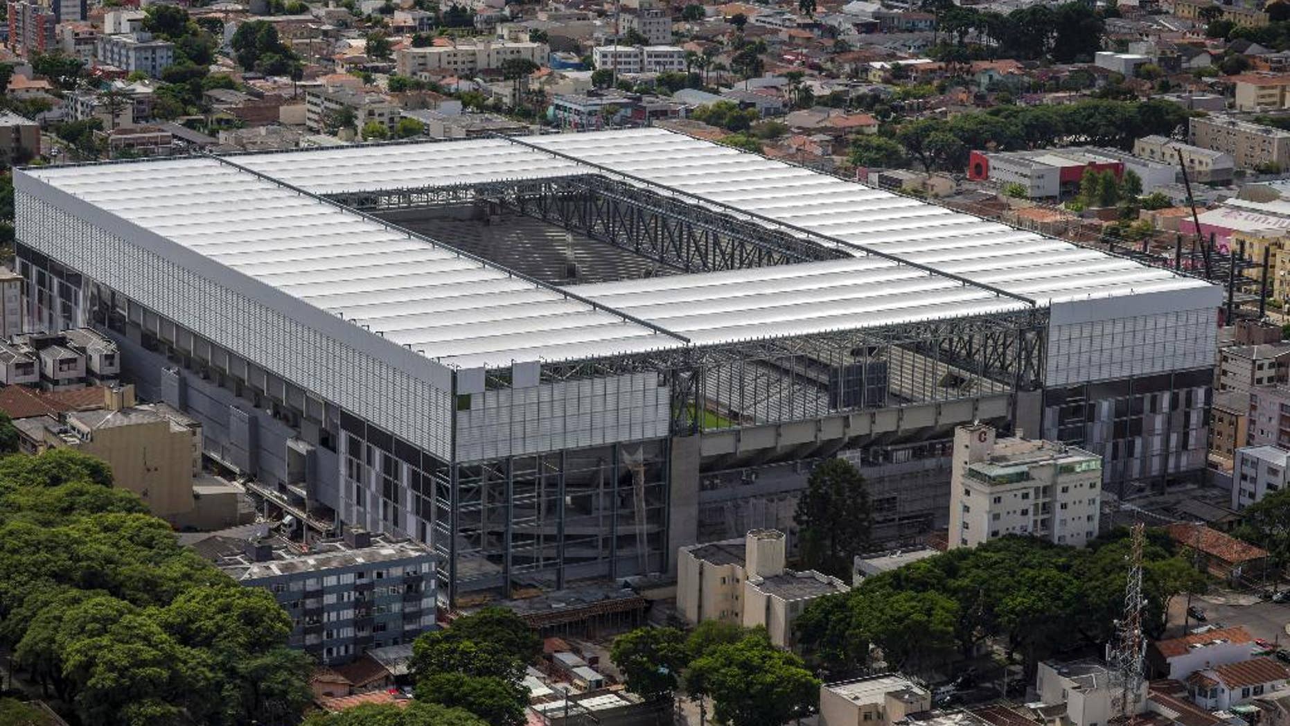 This March 20, 2014 photo released by Portal da Copa, shows an aerial view of the Arena da Baixada in Curitiba, Brazil. It's all coming down to the final 30 days. Brazil had seven years to get ready for the World Cup, but it enters the final month of preparations with a lot yet to be done. The unfinished stadium in Brazil's southern city of Curitiba, was nearly excluded from the tournament by FIFA earlier this year. The first full test at the venue is scheduled for this week.(AP Photo/Portal da Copa, Alexandre Carnieri)