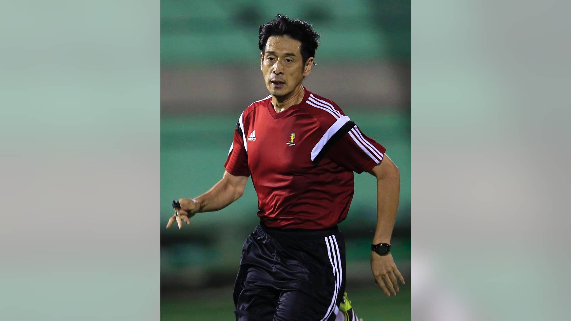 Referee Yuichi Nishimura from Japan runs during a referee's training session in Rio de Janeiro, Brazil, Friday, June 6, 2014. Brazil is hosting the World Cup soccer tournament that starts June 12. (AP Photo/Hassan Ammar)