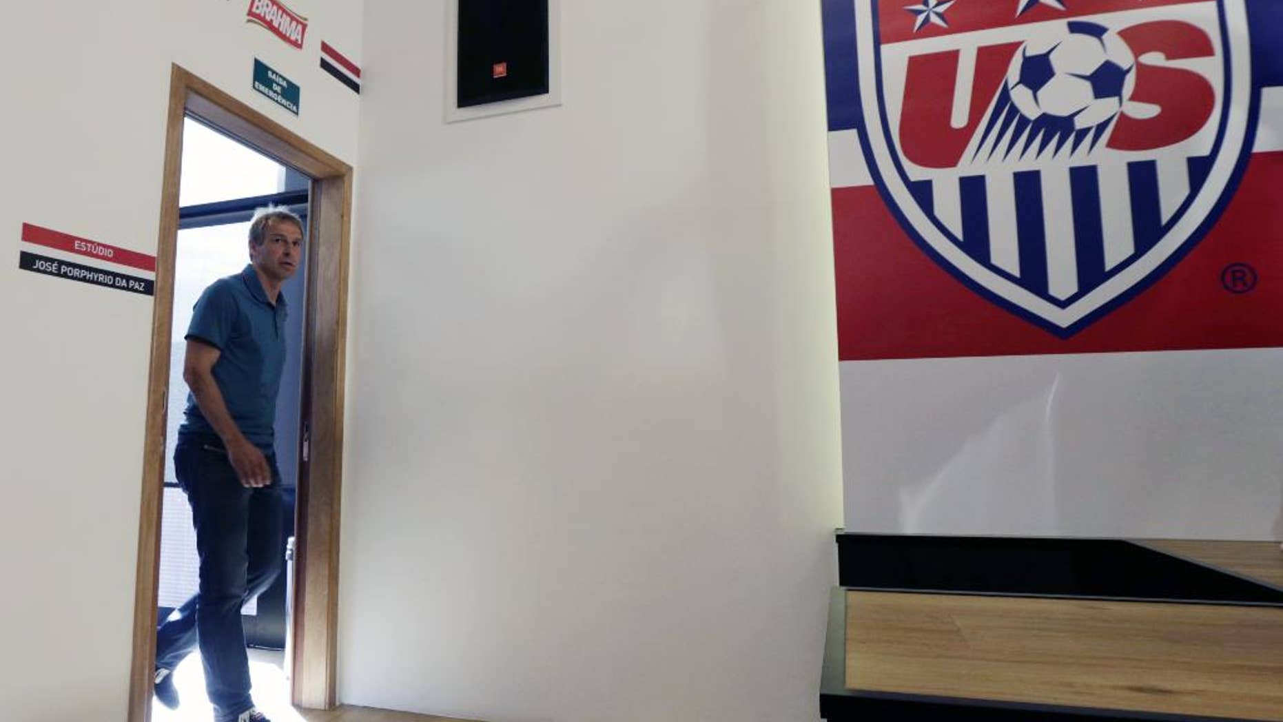United States head coach Jurgen Klinsmann arrives to a press conference in Sao Paulo, Brazil, Wednesday, July 2, 2014. The U.S. was eliminated from the second round of the 2014 soccer World Cup in a 2-1 loss to Belgium in Salvador, Brazil. (AP Photo/Julio Cortez)