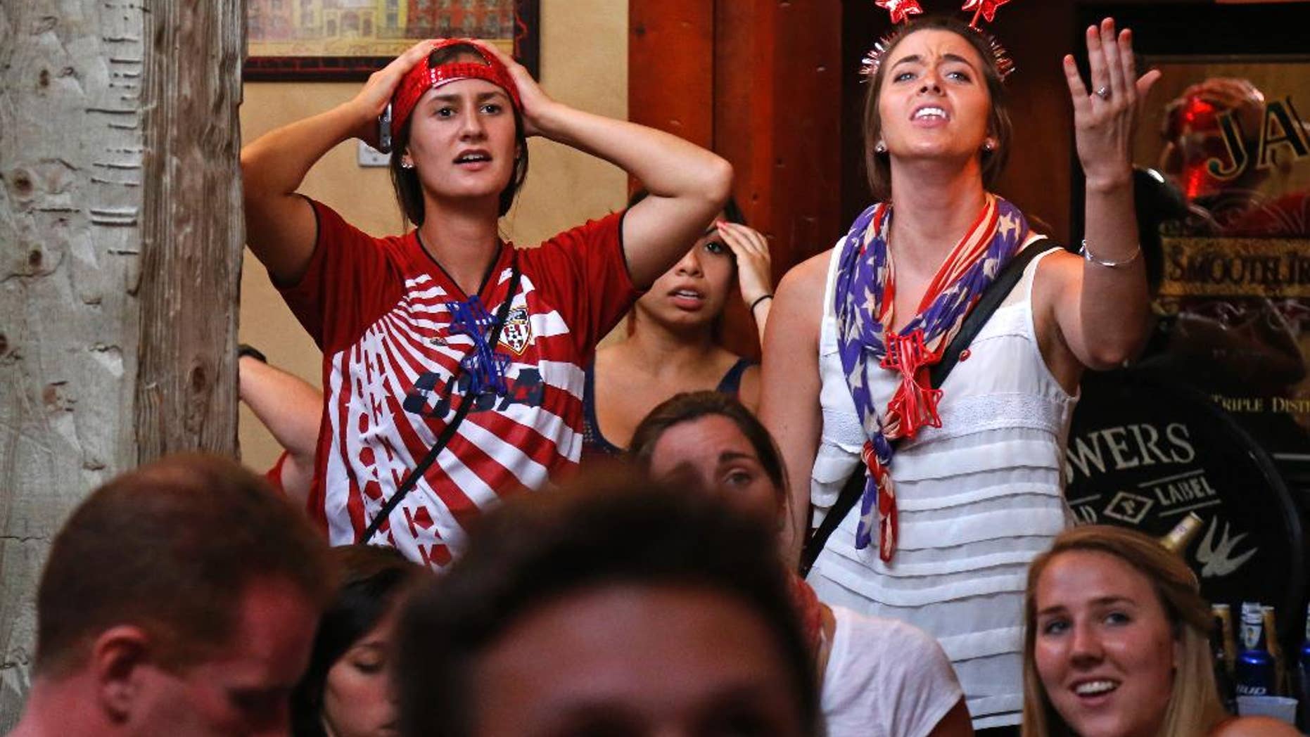 U.S. soccer fans at The Claddagh Irish Pub in Pittsburgh react as Portugal scores to tie the score at 2-2 with less than one minute remaining during a World Cup soccer match against the United States in Brazil Sunday, June 22, 2014. (AP Photo/Gene J. Puskar)