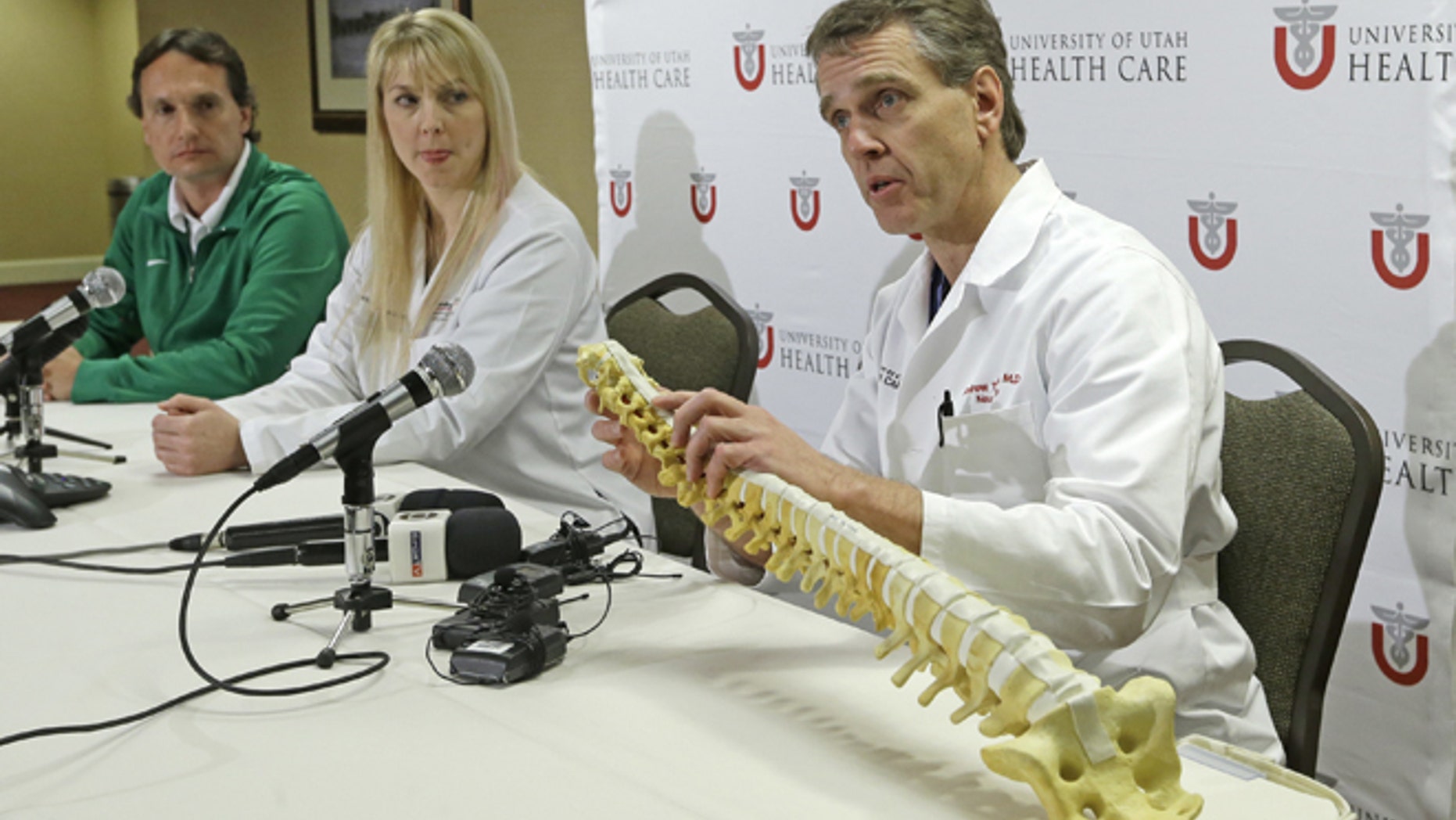 University of Utah neurosurgeon Andrew Dailey, right, describes the injury of Brazilian gymnast Lais Souza, as Brazilian team doctor Antonio Marttos, left, and Dr. Holly Ledyard, member of the University of Utah Neuro Critical Care Unit, looks on, during a news conference at the University of Utah Thursday, Jan. 30, 2014, in Salt Lake City. Doctors say the 25-year-old gymnast, expected to compete in freestyle skiing at the Sochi Olympics, is unable to move, talk or breathe on her own after an accident this week while skiing in Utah. She was injured Monday when she hit a tree while skiing in Park City.(AP Photo)