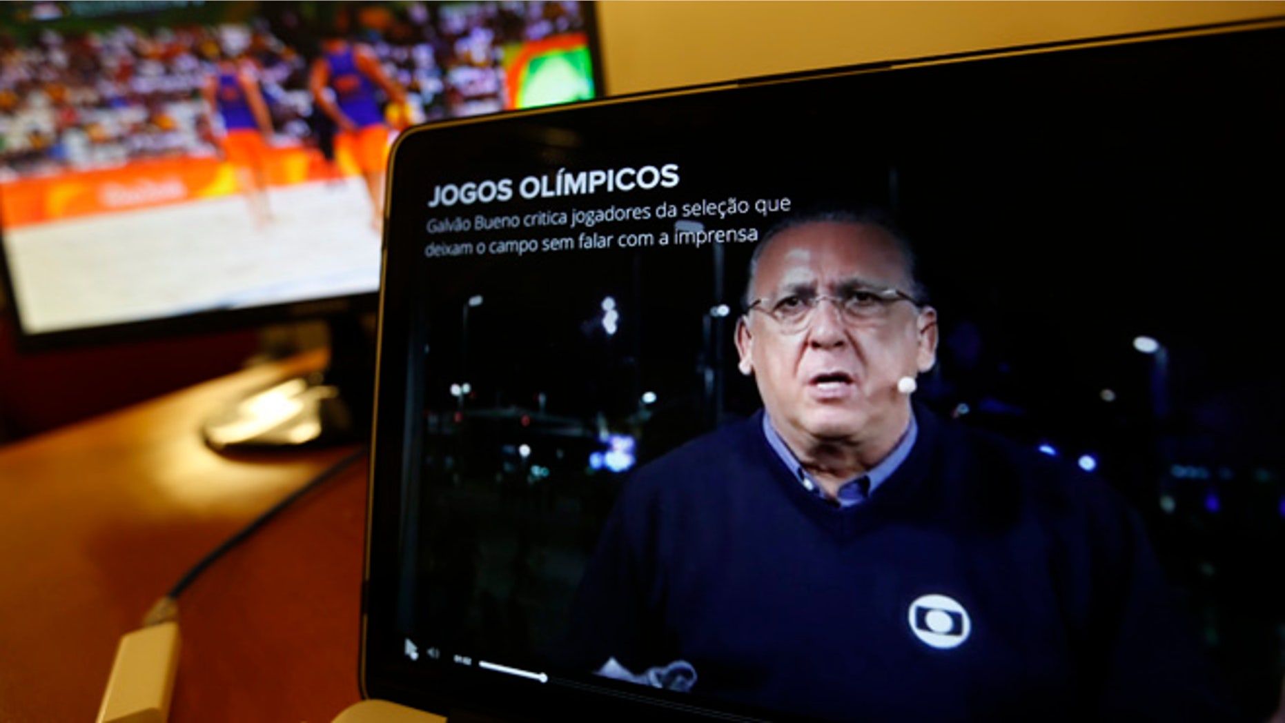 Carlos Eduardo dos Santos Galvao Bueno, chief sports commentator for Globo, is seen on a screen in Rio de Janeiro, Brazil, Monday, Aug. 15, 2016. When a BBC announcer suggested that the Brazilian broadcaster needed to shut up at the start of a swimming race at the Rio Olympics, he was voicing the feelings of many in the host country. Considered the Bob Costas of Brazil, Carlos Eduardo dos Santos Galvao Bueno, known here simply as Galvao, is a love-him-or-hate-him announcer who is the voice of Brazilian sports. His raucous, over-the-top style helps make big sporting events feel even bigger in Brazil. (AP Photo/Silvia Izquierdo)