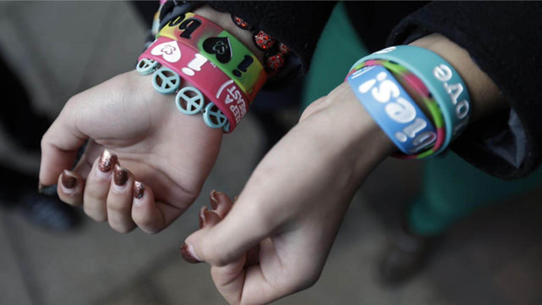 FILE - In this Feb. 20, 2013 file photo, Easton Area School District students Brianna Hawk, 15, left, and Kayla Martinez, 14, display their "I (heart) Boobies!" bracelets for photographers outside the U.S. Courthouse in Philadelphia. (AP Photo)