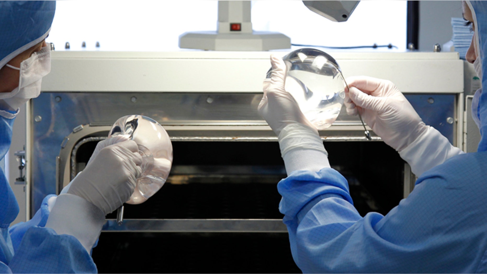 Technicians work in the processing of silicone gel breast implants.