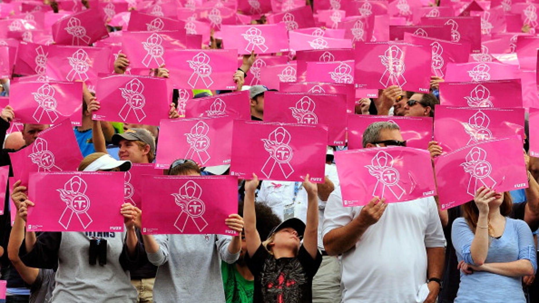Fans salute breast cancer survivors before the start of a game in Nashville, Tennessee.