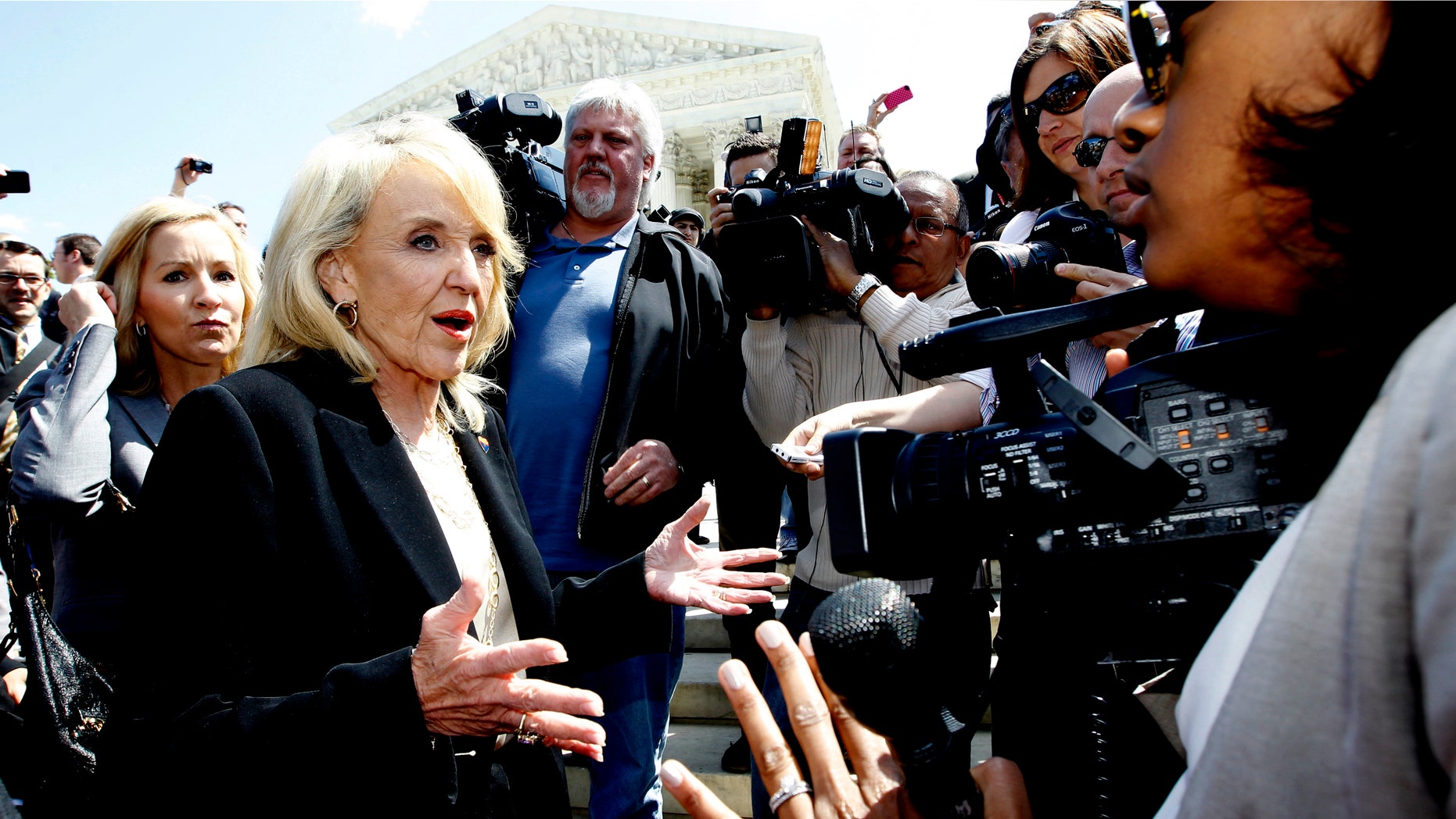 April 25, 2012: Arizona Gov. Jan Brewer speaks to reporters outside the Supreme Court in Washington.