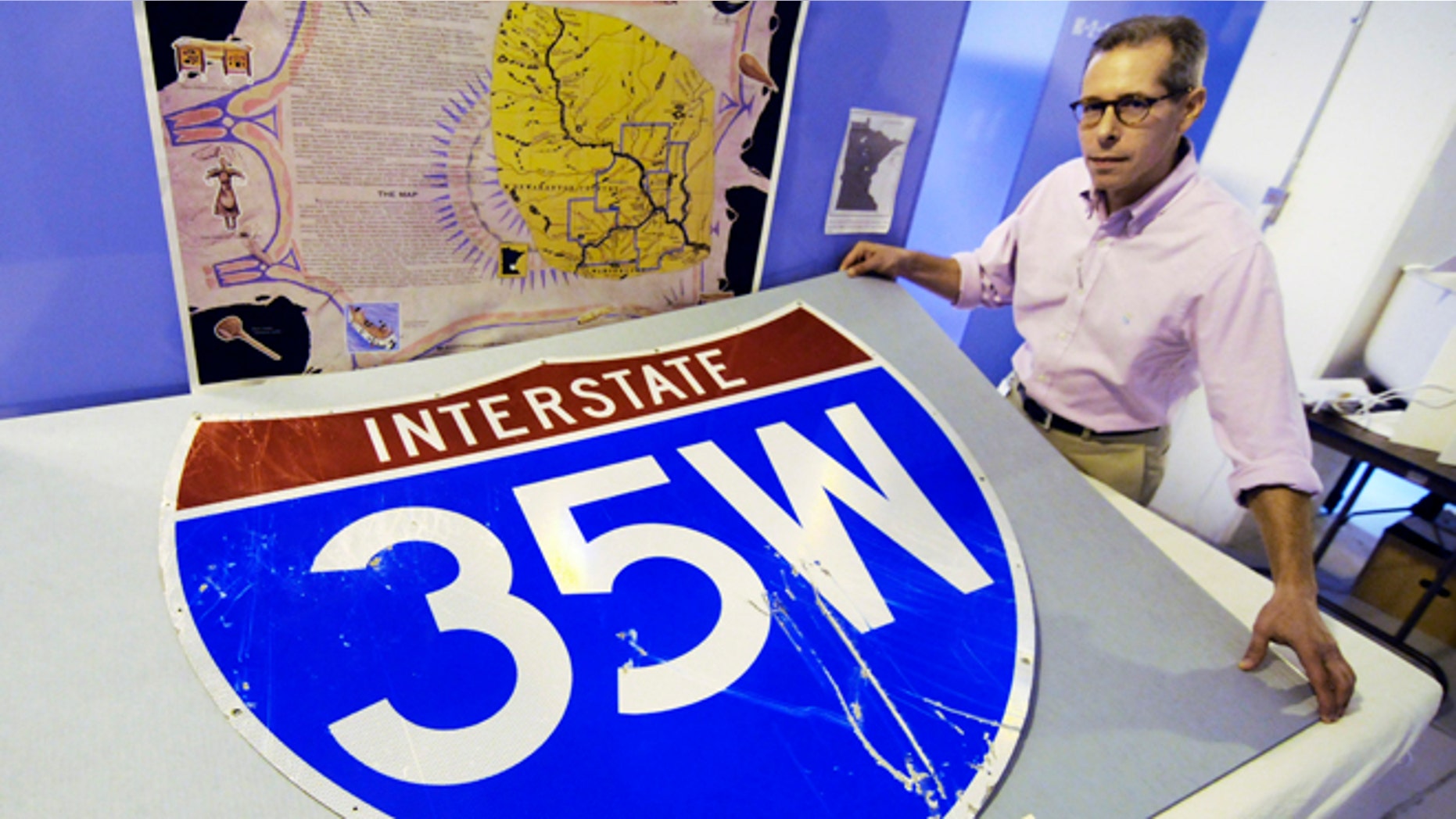 Thursday, July 26, 2012: In this photo in St. Paul, Minn., Minnesota History Center senior curator Adam Scher shows the bridge highway sign, one of the collection of artifacts at the History Center from the Aug. 1, 2007 Interstate 35W bridge collapse in Minneapolis.