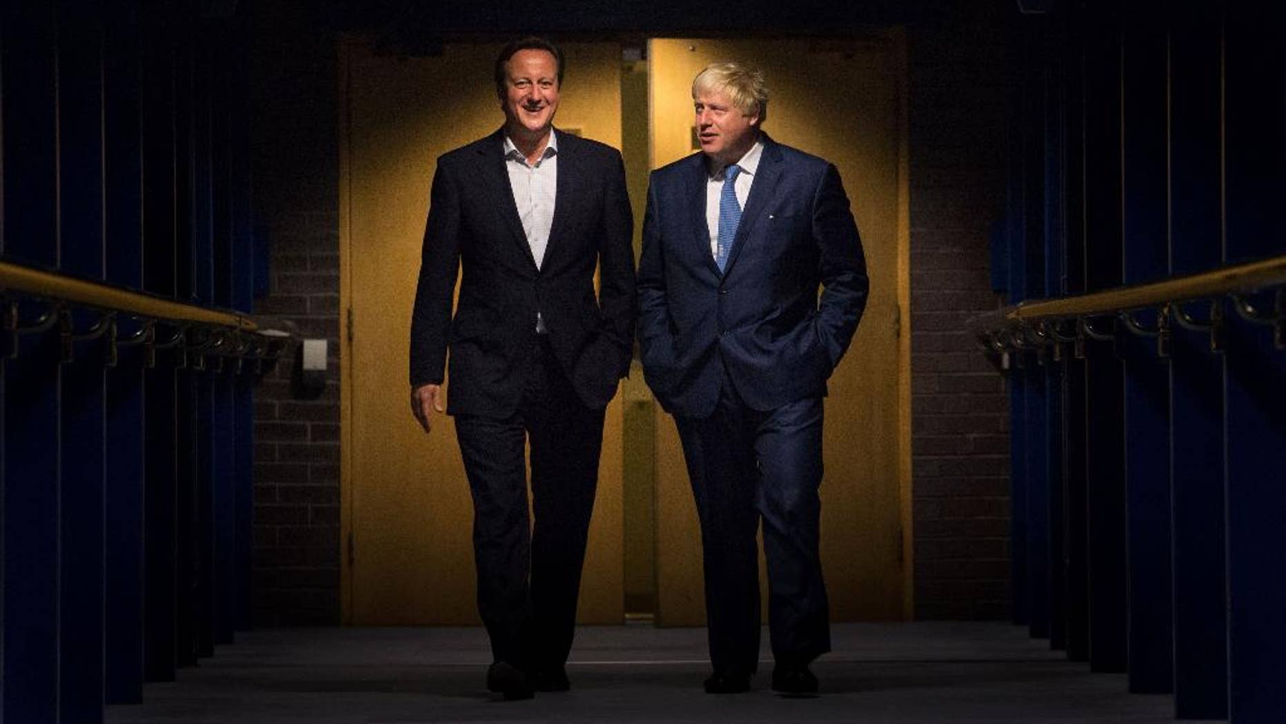 British Prime Minister David Cameron, left and The Mayor of London, Boris Johnson walk through the International Convention Centre, (ICC), in Birmingham, England, Monday, Sept. 29, 2014, on their way to an event, during the Conservative Party conference. (AP Photo/PA, Stefan Rousseau) UNITED KINGDOM OUT