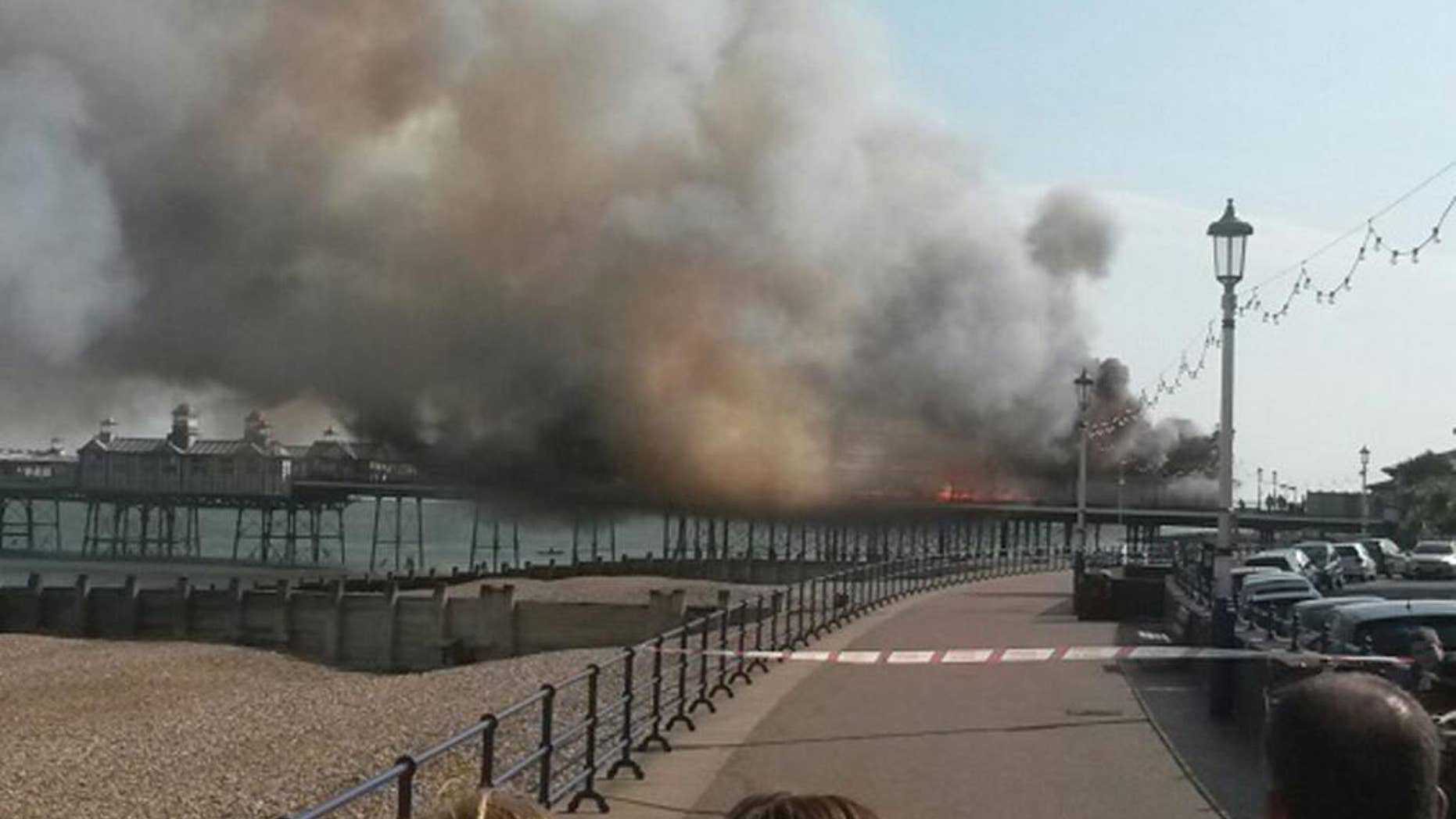 A fire has broken out on Eastbourne Pier, East Sussex, England, Wednesday, July 30, 2014. East Sussex Fire and Rescue Service crews are at the scene of the incident which has been documented by onlookers posting photographs on Twitter. (AP Photo/PA, Tom Pugh) UNITED KINGDOM OUT