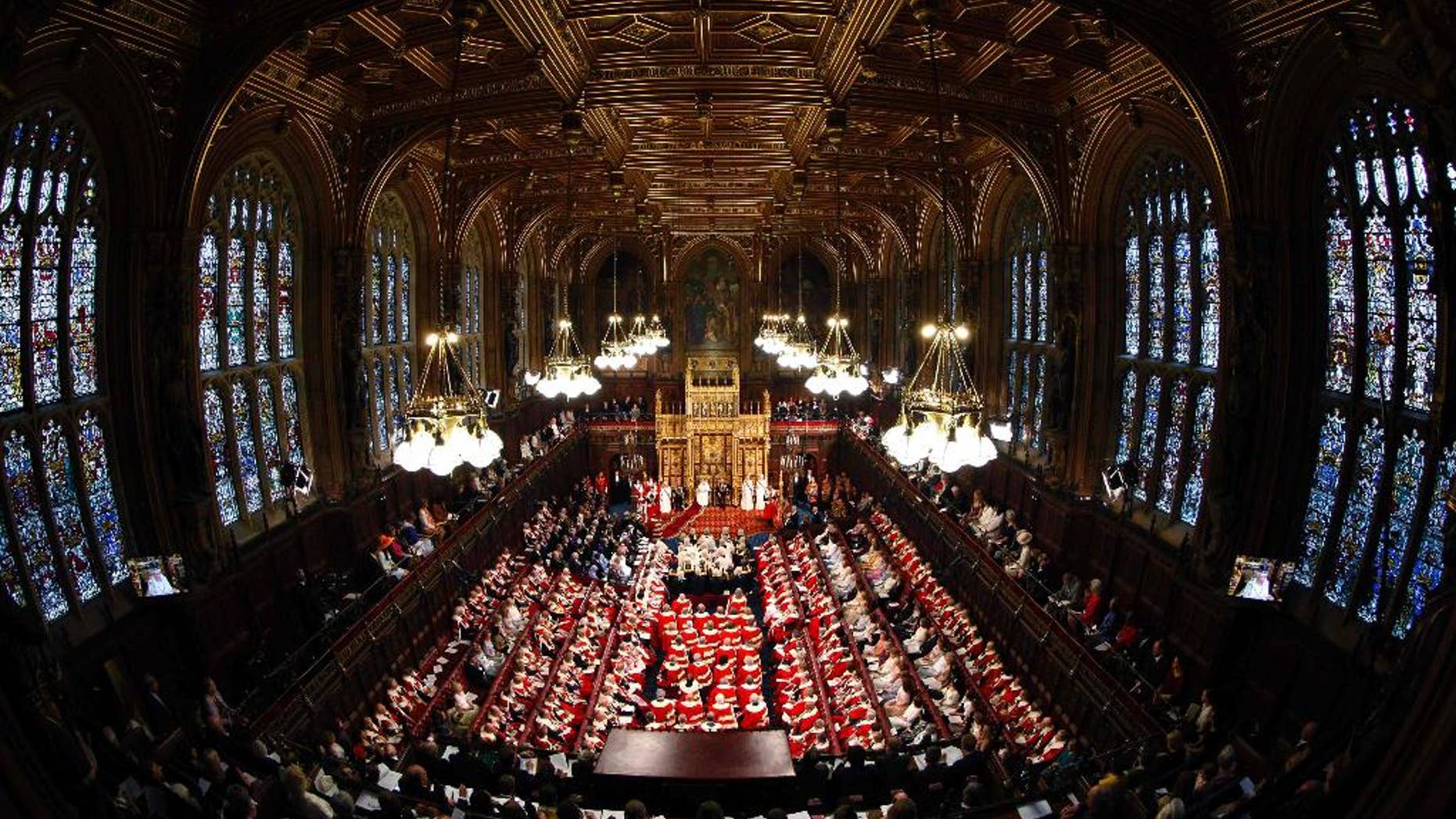 FILE - This is a Wednesday June 4, 2014 file photo of Britain's Queen Elizabeth, rear centre, as she delivers her speech in the House of Lords, during the State Opening of Parliament at the Palace of Westminster in London . An annual speech, read by the monarch at the ceremonial State Opening of Parliament, the Queen's Speech is written by the government and outlines its legislative program. Winning the vote that follows is crucial to the survival of any government. This year's Queen's Speech will be May 27, when either Conservative leader David Cameron or Labour’s Ed Miliband will unveil his government's plans. (Suzanne Plunkett/Pool Photo via AP, File)