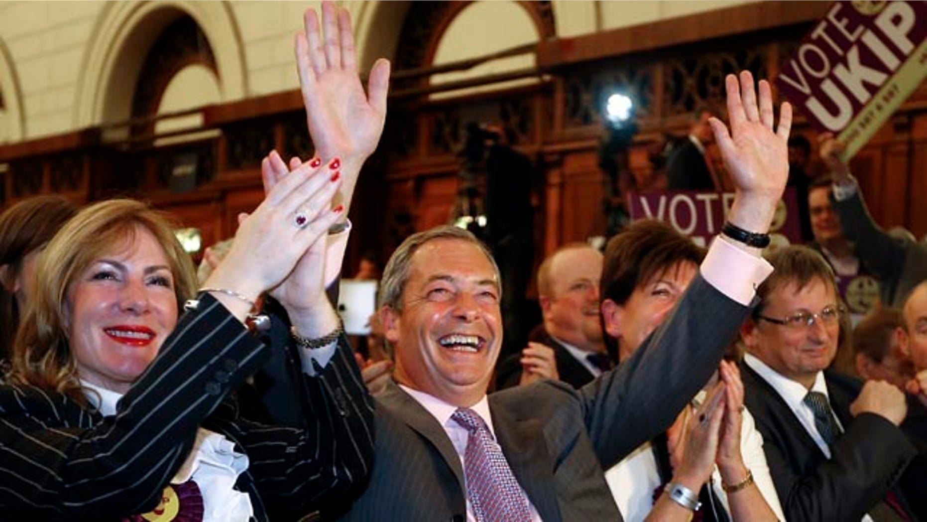 May 26, 2014: Nigel Farage leader of Britain's UK Independence Party (UKIP) celebrates with candidate Janice Atkinson, left, as he hears the results of the south east region European Parliamentary Election vote at the Guildhall in Southampton, England. (AP Photo/Kirsty Wigglesworth)