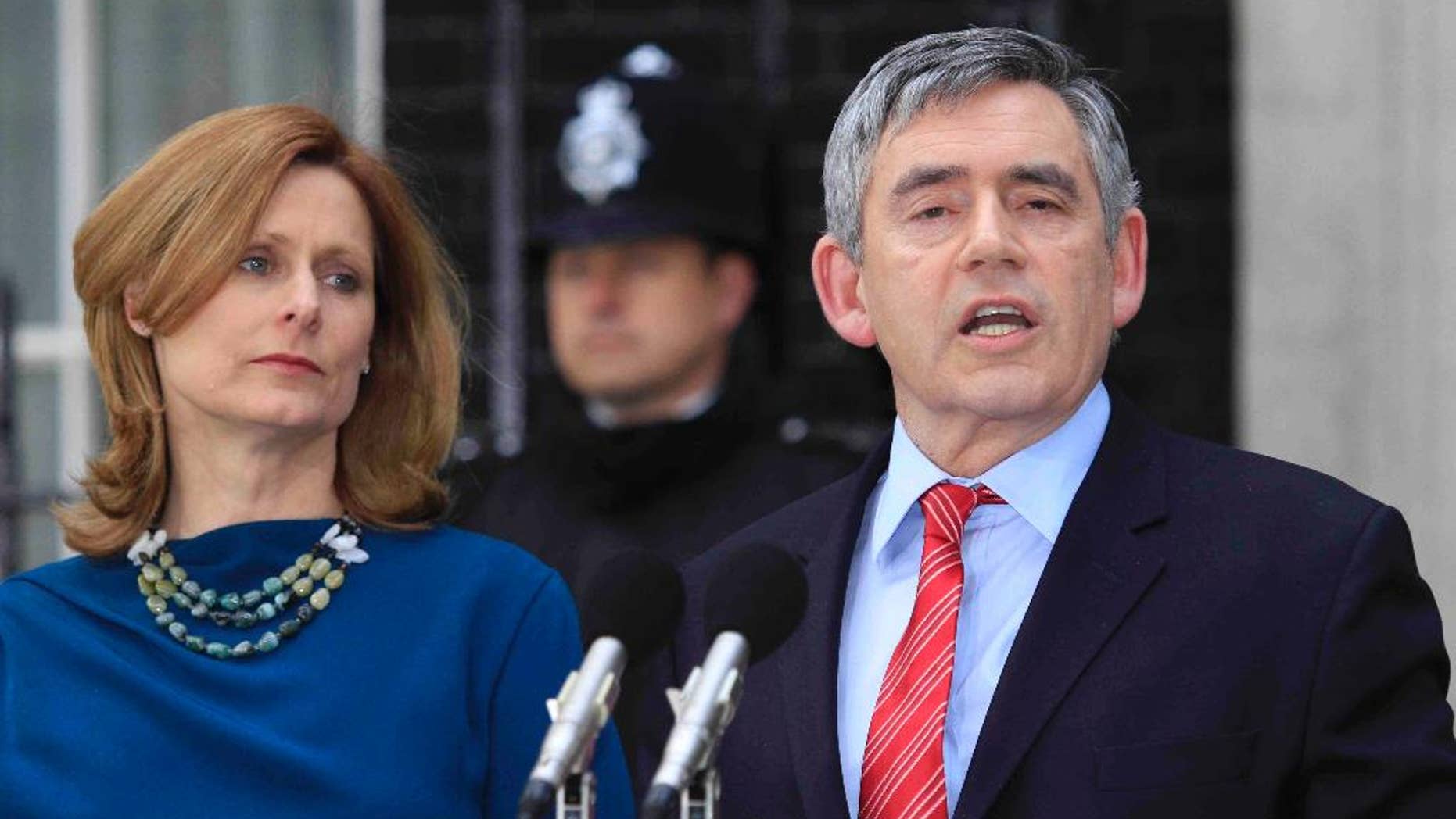 FILE - In this Tuesday May 11, 2010 file photo, Britain's Prime Minister Gordon Brown, accompanied by his wife Sarah, announces his resignation outside his official residence at No. 10 Downing Street in central London. Rivals and allies are paying tribute to former British Prime Minister Gordon Brown, who plans to step down from Parliament at a national election in May. Brown is due to make a speech Monday Dec. 1, 2014 in his home town of Kirkcaldy, Scotland. British media say he will announce he is leaving Parliament after 32 years. (AP Photo/Lefteris Pitarakis, File)